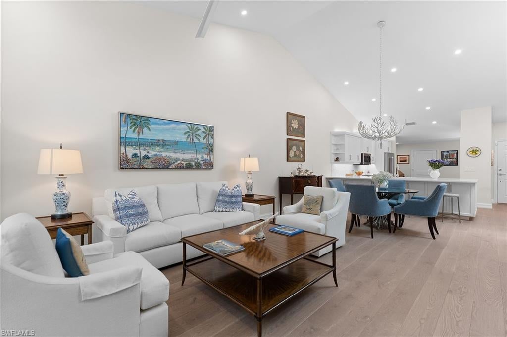 This beautifully renovated residence in Villas of Pelican Bay pairs sophisticated finishes with a calm, inviting aesthetic. Highlights include Legno Bastone oak flooring, plaster-finished walls in a serene palette, fully remodeled baths with custom cabinetry and elegant tilework, and a stone accent wall with a fireplace and large-screen TV. The spacious, open kitchen features an oversized breakfast bar, new quartz countertops, a stylish backsplash, and Thermador refrigerator and dishwasher. The expanded footprint adds a bright Florida room overlooking the garden. Enjoying Southwest Florida’s beautiful weather is a breeze with a private backyard and patio offering welcoming spaces for outdoor grilling. The popular Villas of Pelican Bay community offers a clubhouse with a large pool, spa and clubroom, and welcomes up to two pets of any size. Residents also enjoy full access to Pelican Bay’s exceptional resort amenities, including miles of private beach, two members-only beachfront restaurants, a fitness center, pickleball courts and tennis courts.