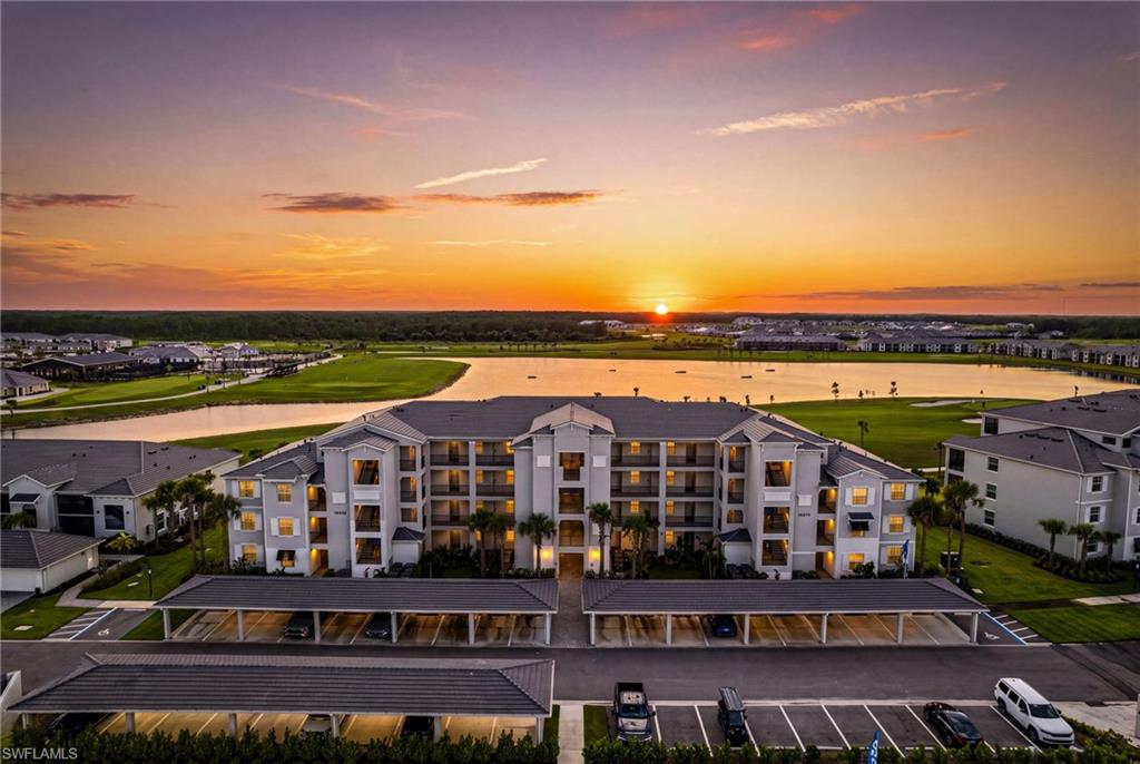 BUNDLED GOLF LAKEFRONT LUXURY WITH SUNRISE VIEWS! Welcome to this beautifully appointed 3-bedroom, 2-bath condo offering breathtaking eastern-facing lake views and unforgettable Florida sunrises from your private screened lanai. Designed with an open-concept layout, this home features a spacious chef's kitchen with quartz countertops, stainless steel appliances, abundant cabinetry, a large center island with seating, and seamless flow into the dining and living areas—perfect for entertaining. The spacious primary suite overlooks the water and offers a luxurious en-suite bath with dual vanities, a walk-in shower, and generous closet space. Two additional bedrooms provide flexibility for guests, a home office, or family. Additional highlights include tile flooring throughout the main living areas, a dedicated laundry room, impact-resistant windows and doors, and covered parking. Enjoy maintenance-free living with resort-style amenities, beautifully maintained grounds, and a prime location close to golf, shopping, dining, entertainment, and Southwest Florida's world-famous beaches. Whether you're looking for a full-time residence, seasonal retreat, or investment opportunity, this move-in-ready condo delivers the perfect blend of comfort, style, and spectacular waterfront living.