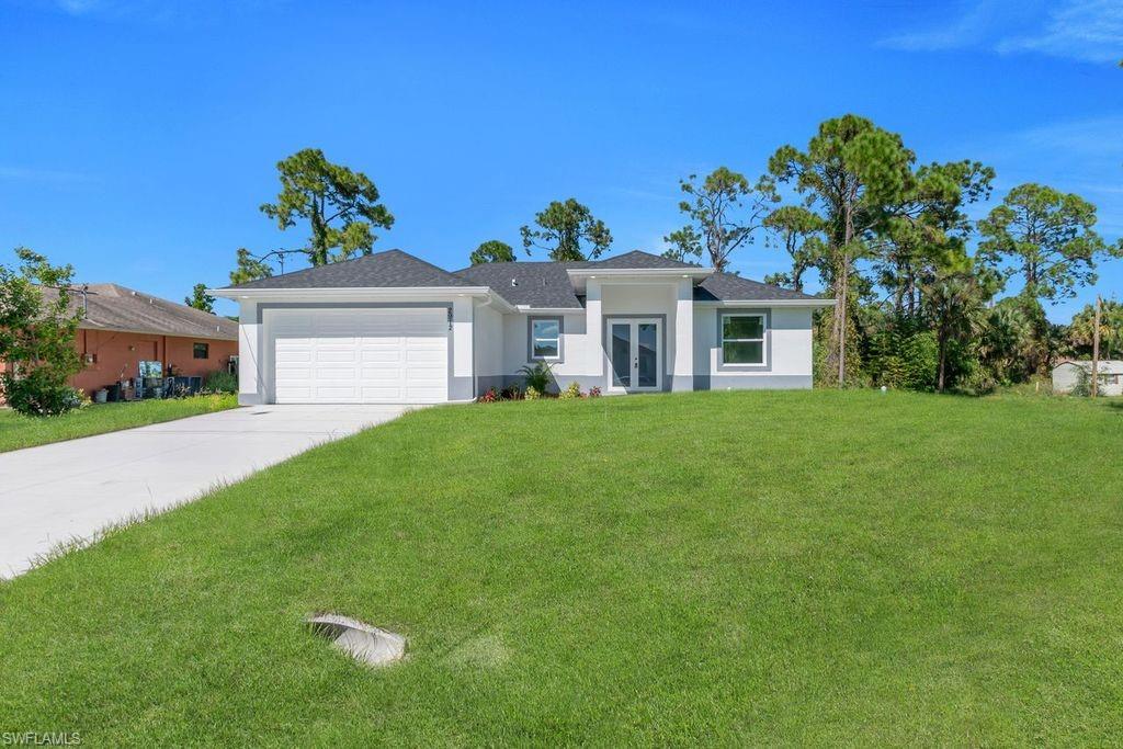 Welcome to an exceptional new construction residence in the heart of Lehigh Acres, where contemporary luxury meets thoughtful design. This impeccably crafted home presents an enticing blend of sophistication and practical living spaces, offering three bedrooms and two well-appointed bathrooms. Step through the elegant double-door entry into a home that exemplifies modern Florida living. The great room design creates an impressive sense of openness, seamlessly connecting living spaces and establishing an ideal environment for both entertaining and daily life. The heart of this home is its beautifully conceived kitchen, featuring a traditional eat-in design enhanced by a generous island that doubles as a casual dining space. Culinary enthusiasts will appreciate the complete suite of new stainless steel appliances, including a refrigerator, dishwasher, microwave, and range. The kitchen's sophisticated aesthetic is elevated by premium quartz countertops, which extend into the bathrooms, maintaining a cohesive design throughout. The primary bedroom suite stands as a private retreat, boasting a spacious walk-in closet and an elegant bathroom with dual sinks. Two additional bedrooms offer comfortable accommodations for family members or guests, while the second full bathroom ensures convenience for all. Throughout the residence, premium porcelain tile flooring creates a seamless flow, reflecting light and contributing to the home's bright, airy atmosphere. All windows feature stylish zebra blinds, adding a touch of modern elegance while offering versatile light control. Safety and durability were paramount in the design, with impact windows and doors providing peace of mind during Florida's seasonal weather. The covered lanai extends the living space outdoors, offering a serene setting for morning coffee or evening relaxation. Professional landscaping enhances the front yard, creating immediate curb appeal and a welcoming approach to your new home. This residence's location proves equally impressive, positioned just blocks from Lee Boulevard and offering swift access to Fort Myers. The neighborhood boasts exceptional educational opportunities, with schools and a public library nearby. Daily conveniences are equally accessible, with shopping and dining options within easy reach. Notably, this property sits outside designated flood zones, offering additional peace of mind. This new construction represents more than just a house; it's an opportunity to embrace a lifestyle where comfort meets convenience, where modern amenities blend seamlessly with practical living, and where every detail has been carefully considered to create an exceptional living experience. Don't let this remarkable opportunity pass you by - schedule your private showing today and step into your future home.