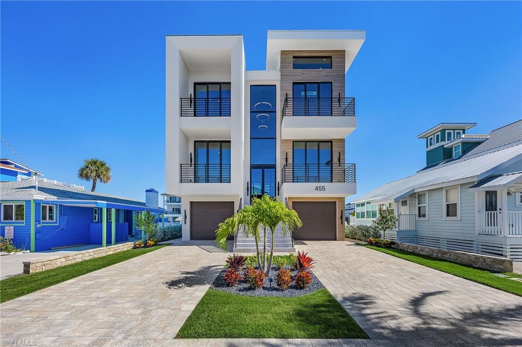Distinguished architectural new construction canal-front pool residence located on Palermo Circle, one of the most coveted streets on the north end of Fort Myers Beach. Primarily concrete construction, this refined contemporary home showcases bold architectural lines and elevated finishes, offering a seamless blend of sophistication, comfort, and coastal design. Designed for both entertaining and everyday living, the home features six bedrooms and six baths, including two expansive primary suites, within light-filled open-concept living spaces. The designer kitchen serves as a focal point with premium appliances, while the walk-in pantry is thoughtfully appointed with a standalone ice maker for added convenience. A dramatic floating metal staircase anchors the interior, complemented by a private elevator providing access to all levels. Both primary suites offer private retreats with tranquil water views, custom detailing, and spa-inspired baths. One suite is further enhanced by breathtaking bay views, creating an exceptional owner’s sanctuary. Outdoor living is elevated with a private heated pool and spa, multiple balconies, and sweeping canal and bay views, with select sightlines extending toward the Gulf of Mexico. Entry is through the garage into a welcoming foyer with direct access to the stairway and elevator. Parking accommodates up to six vehicles, including two garage spaces. Ideally located within walking distance to the beach, pier, shopping, dining, Margaritaville Resort, and the Times Square district, this exceptional residence delivers a premier luxury island lifestyle.
