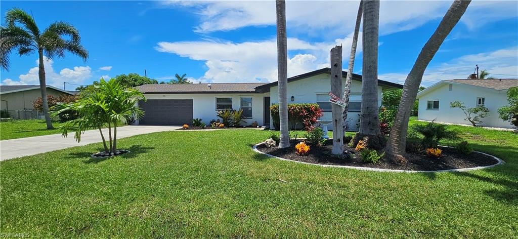 Are you looking for that next peaceful getaway? Then look no further! This stunning single family home boasts 3 spacious bedrooms, 2 luxurious bathrooms, and top-of-the-line features throughout. The kitchen is a chef's delight with granite counters, stainless steel appliances, and ample cabinet space. The elegant tile flooring adds a touch of sophistication to the open concept living area, perfect for entertaining guests or relaxing with family. But the real showstopper is the backyard oasis, complete with pavers and a custom fire pit. Imagine spending evenings gathered around the fire, roasting marshmallows and sharing stories with loved ones. During the day the outdoor space is equally impressive, with a fenced back yard and plenty of room for lounging in the Florida sun. The fun doesn't end there though.... The garage has been tastefully appointed as a game room, complete with pool table and various other games. In fact the entire home has been equipped with your every comfort in mind. Located in South East Cape Coral within close proximity to the downtown area and only a short drive across the bridge to Fort Myers this home offers the perfect blend of luxury, comfort and location. Don't miss your chance to make this your next rental!
