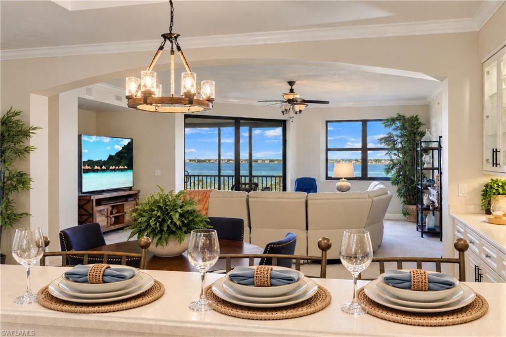 SWEEPING RIVER VIEWS + PRIVATE 2-CAR GARAGE + 2,526 SQ. FT. -- Now available at an INCREDIBLE VALUE!  Located within the prestigious Gulf Harbour Yacht & Country Club and just MINUTES from beautiful Sanibel Island and Fort Myers Beach, this exceptional 3rd-floor Palmas Del Sol residence offers the sought-after Barcelona II floorplan with 2 BEDROOMS PLUS A DEN and 2.5 BATHS and is currently the ONLY residence of this floorplan on the market.

Designed to embrace its waterfront setting, the spacious and inviting layout offers an effortless flow for both everyday living and entertaining. The kitchen features 42" WHITE WOOD CABINETRY, PREMIUM STAINLESS STEEL APPLIANCES, tranquil blue mosaic tile, a center island with cooktop, and separate pantry. The adjoining dining room is elevated by a CUSTOM WET BAR with glass cabinetry and accent lighting, creating the perfect setting for dinners and evening gatherings.    The living room opens seamlessly to one of the home's most compelling features—an expansive 329 sq. ft. ENCLOSED TERRACE with IMPACT-RESISTANT SLIDING GLASS WINDOWS. Enjoy this incredible space year-round while taking in the sweeping Caloosahatchee River views, peaceful mornings, and spectacular Southwest Florida sunsets.  

The primary suite is a private retreat with direct terrace access, a CUSTOM WALK-IN CLOSET, and a spacious ensuite bath featuring dual vanities, a large walk-in shower with bench seating, and a jetted soaking tub. A comfortable guest bedroom and separate den provide flexibility for overnight guests, a home office, or additional living space.  

Setting this residence apart even further is its PRIVATE 2-CAR GARAGE located directly beneath the building—a rare and highly desirable convenience in condominium living, offering secure parking, additional storage, and easy access.
Additional improvements include a NEW TILE ROOF (2024), WATER HEATER (2025), and A/C (2019). Protected by impact-resistant windows, the residence also sustained no hurricane damage.

In addition, residents have the option to join Gulf Harbor Country Club which include a variety of world-class amenities, including golf, tennis, a deep-water marina, and a premier wellness center.  The club is now finalizing an extraordinary $19 million renovation, transforming the clubhouse with expanded indoor-outdoor dining and bar spaces, additional seating, and modern coastal-inspired architecture. The grand debut is planned for Fall 2026.