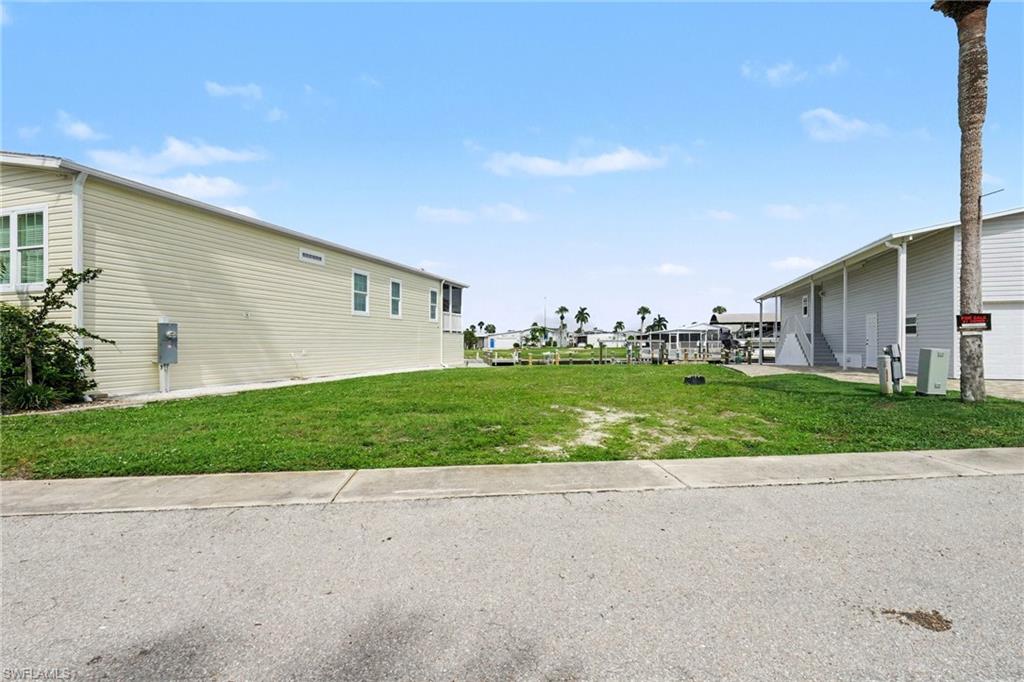 SALTWATER-SIDE WATERFRONT OPPORTUNITY WITH DIRECT GULF ACCESS, SEAWALL, DOCK & 10,000-LB LIFT! Discover a rare opportunity to create your ideal coastal retreat on this cleared waterfront lot in Bayside Estates. Featuring an existing seawall and wraparound dock with direct access to the Gulf of Mexico, this property is perfectly positioned for enjoying Southwest Florida's boating lifestyle. The 10,000-pound boat lift adds even more functionality, offering a convenient setup for keeping your boat right at home.

The lot is cleared and ready for a new manufactured home, giving you the opportunity to create a residence tailored to your vision. Build-to-suit options are available for qualified buyers.

Bayside Estates offers a convenient Southwest Florida location approximately 2.5 miles from the sands of Fort Myers Beach, with easy access to boating, biking, dining, shopping, and area attractions. Community amenities include a clubhouse, pool, planned activities, onsite management, and a low-maintenance lifestyle. HOA fees include lawn care, water, sewer, internet, and reclaimed irrigation.

A one-time $2,800 resale capital contribution fee is paid by buyers at closing. Bayside Estates is a 55+ community. With a cleared homesite, saltwater-side location, seawall, wraparound dock, 10,000-pound lift, and direct Gulf access, this property offers an outstanding opportunity to build your own Southwest Florida waterfront retreat.