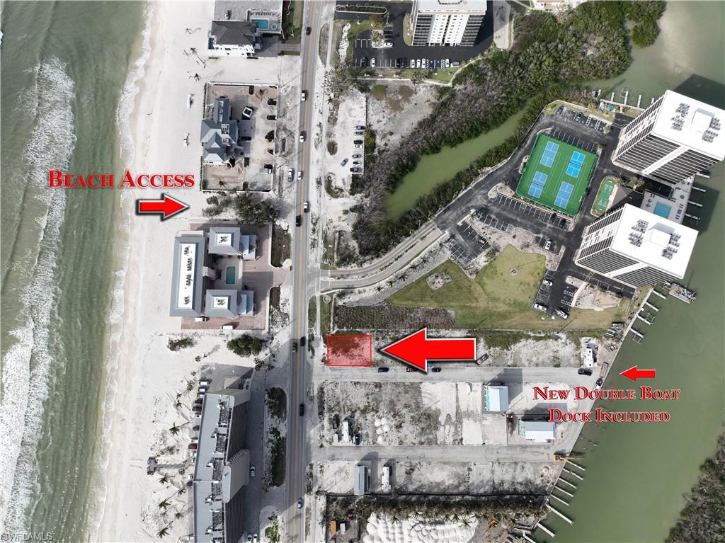 Rare opportunity to purchase a double lot in Bonita Beach Village that is the only property with direct west views of the Gulf of Mexico and has a double boat dock that will allow for a wider beam boat. Other features include: Beach access right across the street, premier boating with the pass to the Gulf just a few minutes away and the ability to boat to Ft Myers or to Naples with never having to go in the gulf, and all utilities are on the lot plus no large impact fees. The building can be two stories over the garage, and garage can be enclosed with garage doors or open pilings with storage. You can build a concrete custom home or order a high end two story modular which will be placed on top of pilings and tie beams. This property is the best priced option to live by the beach, with beach and sunset views, best of boating and low HOA fees. You can build an approximately 1900+ total square foot house per floor or 3800 sq feet total plus the garage area. There are three new homes completed and 4 more are permitted and construction will soon be underway. ALL BOAT DOCKS ARE NEW INCLUDING THE SEAWALL. These reasonably priced lots are the best low cost option to build your new home and enjoy the ultimate in Florida lifestyle.  NOTE: COMMUNITY UPGRADES STATING SOON INCLUDE UNDERGROUND UTILITIES, NEW RAISED PAVED STREETS WITH CURBS AND NEW LANDSCAPING INCLUDING THE ENTRANCE!