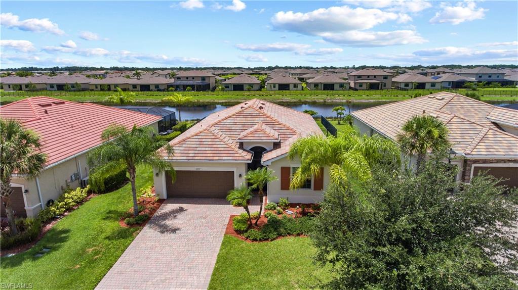 Discover this beautifully maintained 4-bedroom, 3-bathroom home in the desirable Hampton Lakes at River Hall community, perfectly positioned on an oversized lot of more than 10,000 square feet with peaceful pond views. The open-concept layout creates a bright, welcoming atmosphere, while the expansive sliding glass doors fill the main living area with natural light and provide a seamless connection to the backyard and water views.

The spacious primary suite is privately situated at the rear of the home and features two generous walk-in closets and an ensuite bathroom designed for comfort. A secondary bedroom includes its own attached full bathroom, offering added flexibility, while two additional bedrooms share a third full bath.

Outside, the fenced backyard provides plenty of space for outdoor enjoyment, gardening, or future enhancements, all with a tranquil pond backdrop. A long 4-car driveway offers abundant parking in addition to the attached garage.

Residents of Hampton Lakes at River Hall enjoy access to outstanding community amenities, including a clubhouse, resort-style pool, fitness center, pickleball courts, playground, and more. Combining generous indoor and outdoor living spaces with a scenic waterfront setting and exceptional amenities, this home offers the perfect balance of comfort, convenience, and Florida living!