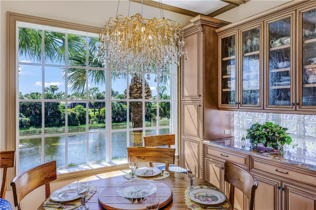 Richly detailed interiors, exquisite millwork & beautifully curated finishes distinguish this THREE-BEDROOM PLUS DEN, THREE-BATH luxury condominium in Oak Hammock at Shadow Wood at The Brooks in Estero, Florida. With a stately library, THREE private bedroom suites & a private elevator, this remarkable residence offers the warmth & character of a classic home with the convenience of condominium living. For those who appreciate fine craftsmanship, there is so much here to admire. Elaborate crown molding, decorative chair rails, richly finished cabinetry & stunning chandeliers bring depth & distinction to the living spaces. An intricately crafted built-in dining room cabinet makes an elegant statement, while the library’s built-in bookshelves create an inviting setting for reading, conversation, or displaying treasured collections. Natural light enhances the architectural details, revealing the care devoted to each room. The beautifully appointed kitchen pairs ornate cabinetry & carved decorative accents with thoughtful functionality. A substantial four-inch-thick quartz countertop anchors the island, complemented by generous storage, convenient pull-out shelving & dimmable undercabinet lighting. KitchenAid stainless steel appliances include an induction range, true convection oven with a separate baking drawer & dishwasher. The adjoining breakfast area offers a lovely place to begin the day. Each of the THREE bedrooms enjoys its own PRIVATE EN-SUITE BATH, providing comfort & privacy for both owners & guests. Upgraded showers feature natural stone or marble tile & heavy frameless glass enclosures, complemented by distinctive fixtures. Behind French doors, the dedicated den offers a polished workspace. The attention to detail continues in the staircase, where thick Shellstone slab treads meet an artisan-finished railing with silver & gold gilding accents. Shellstone flooring, complementary woodgrain luxury vinyl & stone base moldings further enrich the interiors. Even the laundry room is beautifully finished, with more than $30,000 invested in cabinetry, quartz countertops & plumbing upgrades.
A PRIVATE ELEVATOR provides access from the garage, making everyday arrivals effortless. The garage itself features epoxy flake flooring, LED task lighting & smart door openers. Additional improvements include a Lennox HVAC system installed in 2022, a 2021 water heater, Lutron Caséta smart lighting controls, extensive audio/video upgrades & refreshed interior paint. The screened lanai, enhanced with No-See-Um mesh, offers a comfortable space to relax & enjoy the Florida setting. Located in Oak Hammock at Shadow Wood at The Brooks in Estero, this distinctive condominium places shopping, dining & Southwest Florida’s Gulf beaches within convenient reach. Classic, refined & filled with memorable details, this home's craftsmanship deserves to be experienced in person.