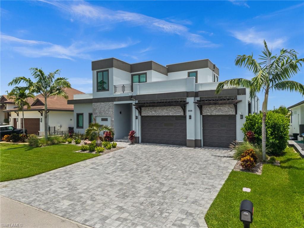 Set along prestigious Bayshore Avenue in Cape Coral's coveted Yacht Club neighborhood, this exceptional waterfront estate redefines luxury coastal living. Built in 2021 and offering 4,380 square feet of impeccably designed living space, this architectural masterpiece presents 7 bedrooms, 5 full bathrooms, and 2 half baths, blending timeless elegance with state-of-the-art technology in one of Southwest Florida's most sought-after boating locations.

A dramatic arrival leads to interiors defined by soaring 12-foot ceilings, expansive porcelain flooring, and walls of glass highlighted by 10-foot disappearing edge sliders that dissolve the boundaries between indoor and outdoor living. The spacious great room is anchored by a sleek electric fireplace, while plantation shutters throughout add warmth and sophistication.

Designed for the culinary enthusiast, the gourmet kitchen features premium Miele appliances, exquisite Calacatta Monticello quartz countertops, and an impressive 250-bottle wine cooler—creating an ideal setting for both intimate gatherings and grand-scale entertaining.

Every modern convenience has been thoughtfully integrated. This fully automated smart home allows effortless app-based control of the pool, blinds, and climate systems, while three air-conditioning units, an 80-gallon water heater, and an EPDM membrane roofing system provide exceptional comfort, efficiency, and lasting peace of mind.

Beyond the disappearing sliders, the residence transforms into a private waterfront retreat. The resort-style pool features a sun shelf, elevated spa, and generous entertaining spaces designed to embrace the Florida lifestyle. An outdoor shower adds convenience after a day on the water, while the private dock, completed in 2022, with a 20,000 pound boat lift installed in 2025, offers direct Gulf access with no bridges and quick access to the Caloosahatchee River—making this a true paradise for yacht owners and boating enthusiasts.

Offering the added confidence of no flooding, this remarkable residence delivers the rare combination of superior construction, luxurious finishes, smart-home technology, and an unrivaled waterfront lifestyle. Perfectly positioned within the prestigious Yacht Club neighborhood and surrounded by multimillion-dollar estates, this is an extraordinary opportunity to own one of Cape Coral's premier luxury waterfront properties.
