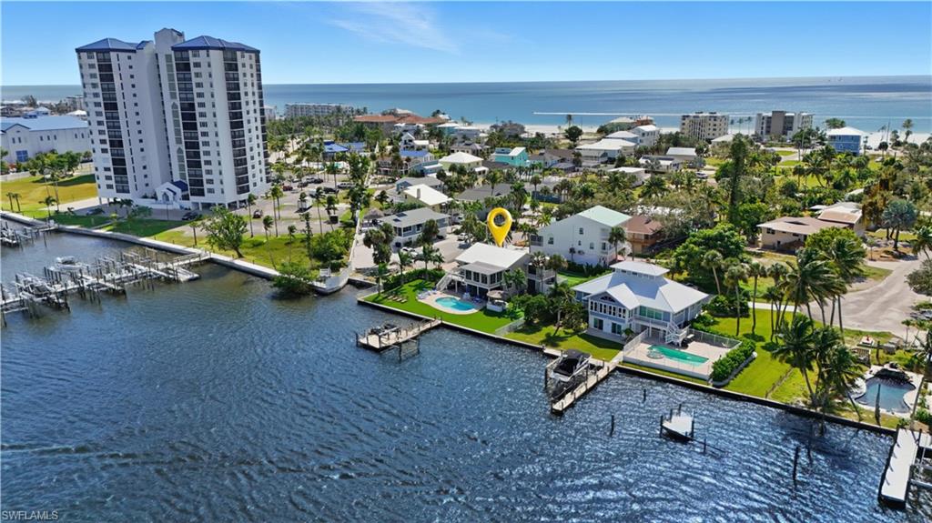 One or more photo(s) has been virtually staged, AI generated or rendered.  Welcome to 205 Bayview Avenue, a rare bayfront pool home on Fort Myers Beach where exceptional waterfront living, an expansive homesite, and strong rental potential come together in one remarkable property.

Set on a generously sized lot with wide bay views, this renovated residence offers a sense of space and privacy that is increasingly difficult to find on the island. The waterfront setting is the true centerpiece, with peaceful views across the bay and frequent sightings of dolphins, manatees, and coastal wildlife just beyond the shoreline.

Inside, the home has been thoughtfully updated on both levels and features three bedrooms plus a den and three full bathrooms. The flexible layout lends itself beautifully to full-time living, a second home, or vacation rental use. The upper level includes a chef’s kitchen and full bar designed for entertaining, while the lower level offers a separate kitchenette for added versatility and guest accommodations.

The home is located on a direct beach access street, allowing you to enjoy both bayfront and beachside living with ease. Just one block north of Publix and close to mid-island dining, shopping, and entertainment, the location offers outstanding convenience without sacrificing the quiet residential atmosphere.

With its substantial lot size, bay frontage, renovated interior, flexible floor plan, and prime mid-island location, 205 Bayview Avenue presents an exceptional opportunity for buyers seeking space, waterfront lifestyle, and long-term value on Fort Myers Beach.

Whether envisioned as a private island retreat, income-producing vacation property, or future waterfront estate, this is a property with remarkable versatility and potential.