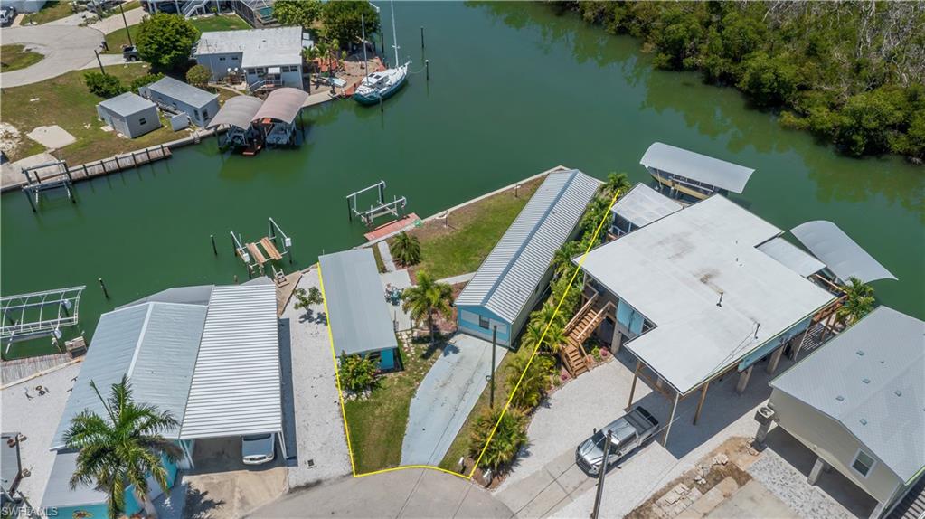 Corner lot with easy access to the Gulf. A nice mobile home with two bedrooms and two baths newer floors, kitchen cabinets,  and paint. Property has a 5x12 dock with a boat lift, there's also a concrete building that is 12x36.