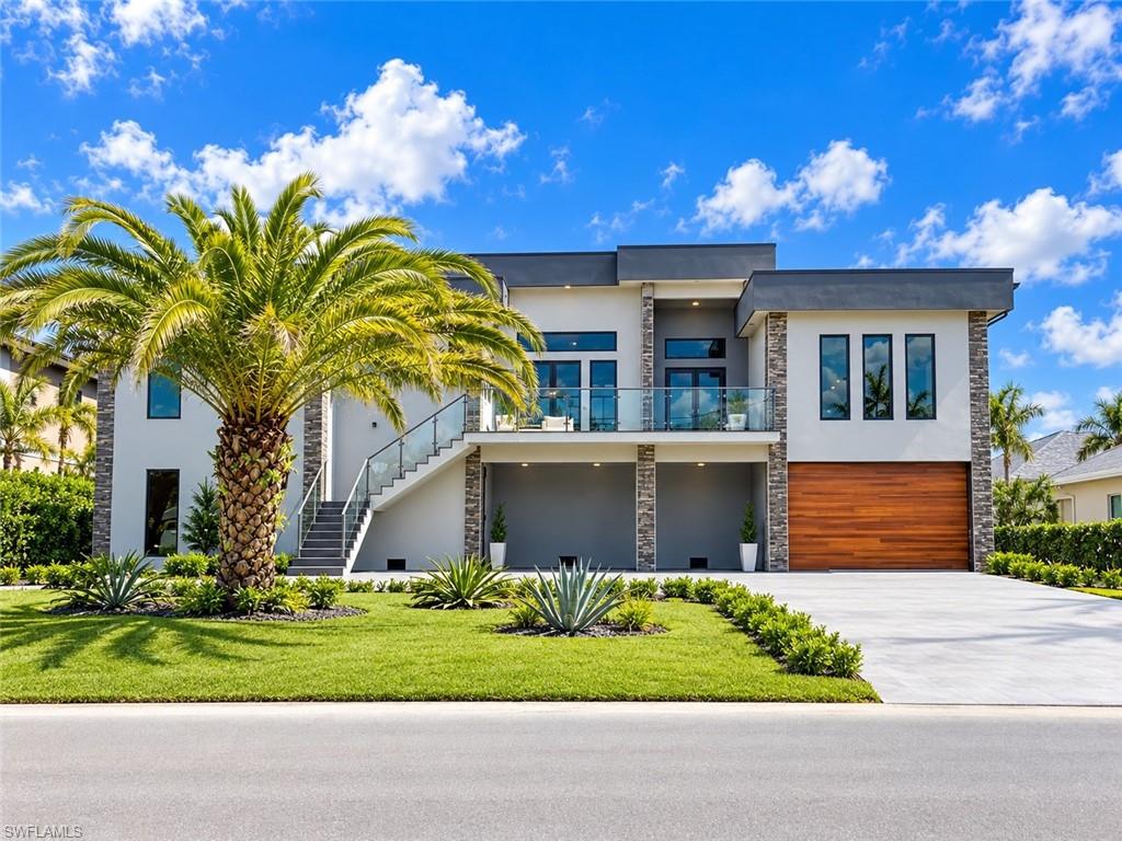 Welcome to an exceptional modern waterfront residence where sophisticated design, generous living spaces, and breathtaking views come together to create the ultimate Florida lifestyle.

This impressive 4-bedroom, 4.5-bath home features two luxurious primary suites, each designed as a private retreat with spacious walk-in closets and beautifully appointed en-suite bathrooms offering walk-in showers, soaking tubs, and double vanities. Two additional guest suites one included their own private en-suite bathroom, the other has the bathroom next door, providing outstanding comfort and privacy for family and visitors.

The heart of the home is the expansive designer kitchen, created for both everyday living and effortless entertaining. It features premium appliances, a large refrigerator and dishwasher, an oversized center island with integrated cooktop and retractable ventilation hood, a wine cooler, abundant cabinetry, and generous preparation space. The open-concept design flows seamlessly into the spacious living and dining areas, enhanced by custom built-ins, contemporary finishes, and elegant indirect lighting that creates a warm and refined atmosphere throughout.

A private elevator provides convenient access between levels, adding an extra level of comfort and functionality to the home. A dedicated laundry room offers appliances, extensive cabinetry, for added convenience.

Designed with the Florida lifestyle in mind, the home is elevated on stilts and supported by deep pilings, creating an extraordinary amount of covered ground-level garage and storage space. The garage has 3,674 sqft , there is ample room for multiple vehicles, boats, recreational equipment, and all the toys that come with waterfront living.

Impact-resistant windows, expansive impact-rated sliding glass doors, and an impact-rated front entry provide added protection while allowing natural light to fill the home and showcase the surrounding views.

Step outside to your private resort-style retreat. The spectacular pool features an integrated spa with elegant champagne overflow, a spacious sun shelf, and a decorative fountain. The expansive porcelain-tiled pool deck provides abundant space for lounging, entertaining, outdoor dining, and enjoying sunrises in the morning.

From the pool area, terraces, and balconies, take in sweeping river views and the stunning downtown skyline illuminated at night. These exceptional outdoor living spaces create the perfect setting to enjoy Florida sunshine, waterfront breezes, and year-round indoor-outdoor living.

Porcelain tile finishes extend across the driveway, pool deck, and upper terraces, beautifully complementing the home's contemporary architectural style. Three separate air-conditioning systems provide enhanced comfort and efficiency throughout the residence.

With resort-inspired outdoor spaces, this remarkable residence offers an exceptional opportunity to experience sophisticated Florida living at its finest.