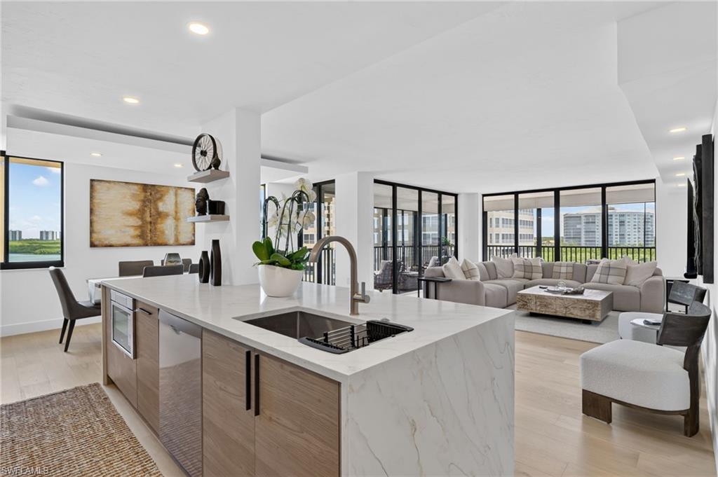 Newly completed and reimagined from the ground up, this corner residence at Vanderbilt Beach delivers the feel of new construction with an exceptional waterfront setting. A new Certificate of Occupancy was issued in July 2026, following a comprehensive transformation of the 2-bedroom, 2-bath home.

Offering 1,480 square feet under air and 1,835 square feet of total living space, the residence is filled with natural light and enjoys water views from every room. The spacious wraparound screened lanai connects seamlessly to both the great room and primary suite, creating an ideal setting for enjoying the waterfront surroundings.

The redesigned interior features a custom European kitchen with quartz countertops, oversized island, Bosch appliances, wine bar and wine refrigerator, along with natural wood flooring, porcelain tile baths, custom closets, glass-enclosed showers and quartz vanities. Additional features include a tankless water heater, storm-rated aluminum shutters and covered end parking.

Arhaus and Z Gallerie furnishings are also available for purchase, offering an opportunity for a beautifully furnished, turnkey residence.

Community amenities include a renovated lobby, fitness center, guest parking and a private marina with boat slips available for lease. Vanderbilt Beach and Delnor-Wiggins Pass State Park are just steps away, with Mercato's shopping, dining and entertainment only minutes from home. The community allows up to nine rentals per year, and required building reports have been completed with all current assessments paid.

A distinctive waterfront property combining thoughtful design, boating access, beach proximity and rental flexibility in one of Naples' most desirable coastal locations.