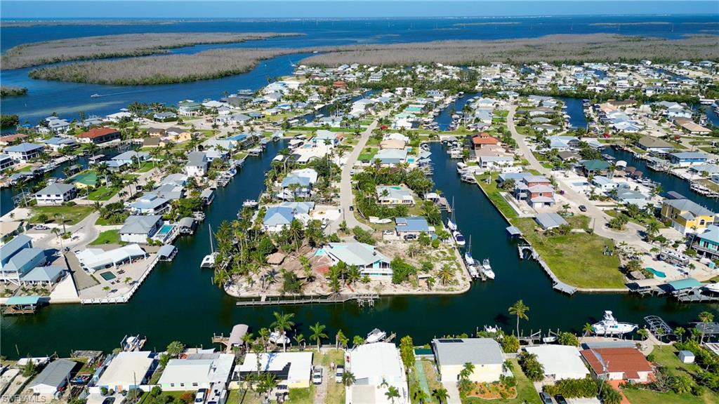 Bring your Sailboat.. ! Intersecting canals, seconds from Open water and San Carlos Bay. Seawall, Very desirable SW direction... Dock with lift and  2- Chickee Huts . Once sold you won't have this opportunity to purchase this type lot and build YOUR home so close to San Carlos Bay, there isn't any more left.!! This lot was part of a 3-lot Estate and Lot-11 & Lot 12 (with a house) are also now for sale !!! At this Location, at this price and before it's gone, Please check this property out NOW !!!!