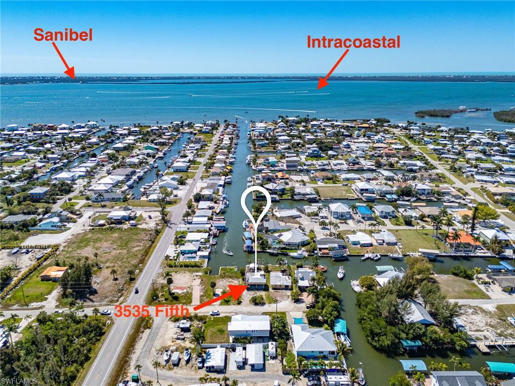 It’s all about the location, location!  Beautiful views looking south down the canal to the bay and Sanibel Island!  Resilient concrete piling foundation in place providing the solid base for your future coastal retreat.  Whether you are a builder/contractor, investor, or a buyer ready to live on island time, take advantage of the groundwork that is set on this blank canvas; now is your chance to design your ideal waterfront dream home that showcases those fantastic water views.  Your Pine Island lifestyle awaits!  Located on intersecting canals, with direct, deep water access to the Intracoastal Waterway, this property is a boater's paradise.  Access the open waters with ease, whether you’re heading out for a day of fishing, exploring the beautiful nearby islands and Gulf beaches, or simply enjoying a sunset cruise.  Charter guides and fisherman take note.  Great visibility on a busy canal with quick access to some of the best fishing in Southwest Florida!  Picture your evenings spent entertaining friends and family in the comfortable backyard with covered bar area overlooking the canal.  Property features include a boat lift and dock, shared cut-in boat slip, mature landscaping, outdoor shower, enclosed downstairs storage/utility room, 30 amp RV hookup, and a detached shed.  Plenty of parking for cars, trailers, boats, and even an RV.  Enjoy the convenience of walking, biking, or hopping on your golf cart, and in minutes being at all the restaurants, bars, shops, and fun that St. James City has to offer!  Seller financing available.  Make your offer today!