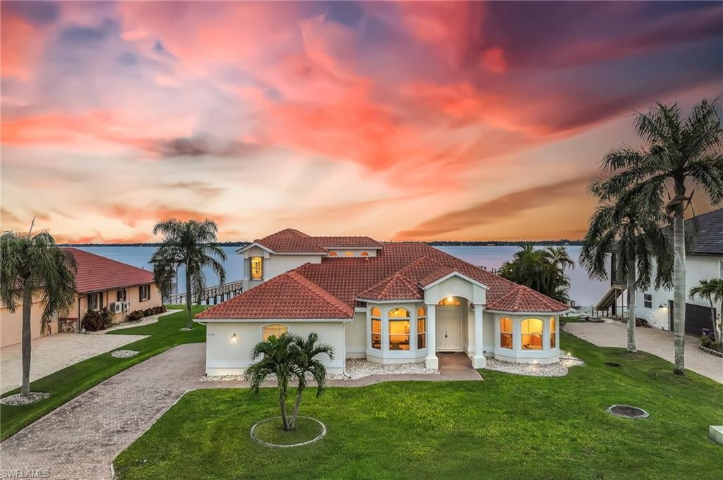 Tucked away at the end of a quiet cul-de-sac in the beautiful Riverwatch community, this riverfront retreat pairs a private, peaceful setting with panoramic views of the Caloosahatchee River. Set on a very generous .43-acre lot, this four-bedroom, three-bath residence offers nearly 3,000 square feet of SOUTHERN facing waterfront living designed for those who love being on the water as much as they love coming home to it.

For the avid boater, a deep-water dock and 25,000-pound boat lift put your next adventure just steps from your door. With direct Gulf access and no bridges, locks, or canals to navigate, you can head straight onto the river for a day of fishing, waterfront dining, or exploring Southwest Florida’s islands and coastal destinations. Here, expansive open-water views and the freedom to get out on your boat are part of everyday life.

Inside, soaring ceilings and sweeping river views create an impressive welcome. The layout draws your attention to the water, with a river-facing kitchen that flows into a dining area framed by large windows. A spacious den or office behind elegant glass French doors offers a quiet place to work or unwind.

Two primary suites - one upstairs and one downstairs - provide comfort and flexibility for owners and guests alike. The downstairs suite opens directly to the lanai, inviting you to start your morning with coffee and river breezes or settle in for a peaceful evening overlooking the water. Outside, the expansive lot offers room to envision a custom pool and beautifully appointed outdoor entertaining space that takes full advantage of this exceptional setting.

Thoughtful improvements include new paint inside and out Sept 2026, a new roof in September 2023, a new seawall in May 2023, new upstairs carpeting in January 2026, and an epoxy-coated garage floor completed in December 2025. Impact windows, along with accordion and electric roll-down shutters, provide added storm protection. 

Secluded in feel yet conveniently connected, this tucked-away neighborhood places you within easy reach of the Fort Myers River District, shopping, dining, and I-75, with waterfront restaurants and marina destinations to explore by boat. A rare opportunity to enjoy the privacy you crave, the river views you dream of, and a boating lifestyle that makes every day feel like an escape!