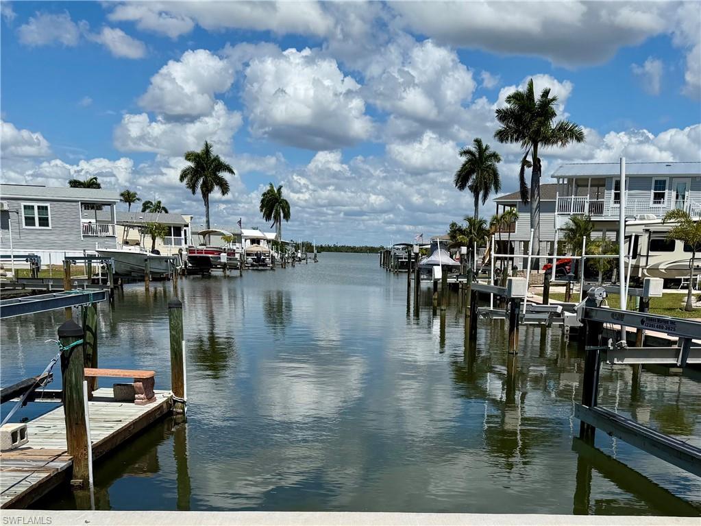 Price reduction! spacious canal lot with a great location which offers a great opportunity to build an exceptional elevated home. This Lot orientation offers a rear facing long canal view minutes from the pristine Estero Bay.  Smart owners recognize the opportunity to enjoy low fees with amenities in this 55+ community.  Port Carlos Cove is an active lifestyle boating community geared to those who want to live life fishing, boating, exploring the back bays & socializing in a beautifully refurbished clubhouse with amenities. Amenities include: New Community Pool & renovated clubhouse, Pickle Ball, shuffleboard, Bocci, and an active social club. LOW HOA FEES-yes--$200 PER MONTH includes: Water, sewer, irrigation, seawall, landscape, pool maintenance. A two minute commute to the unparalleled, pristine Estero Bay awaits. If you own an RV, you will be able to keep it on your parcel while you design your home!  Conveniently located very close to great restaurants and on a canal that is dredged in perpetuity by Lee County! Zoning options include stilt build or Modular style home. Please note that the modular home shown as depicted are presented on this site are for suggestion purposes only. Dramatic Miami style design plans are available with several flexible buyer options if you are interested. Lot will provide a spacious 2/3 bed/2 bath home + ample room for a design with  back sitting area overlooking the canal and will provide ample parking & easy placement of stair access.  Port Carlos Cove resides in Lee county jurisdiction; no impact from Ft. Myers beach restrictions! Also, the reinforced bulkhead on site is well maintained. As an owner, you will enjoy an easy cruise to explore & fish the back waters of the renown ESTERO BAY, PLUS DIRECT GULF ACCESS WITH NO BRIDGES! Port Carlos is perfect community to grant dramatic views where you will see Bald Eagles, Osprey, manatee, spotted eagle rays, Dolphins, fish jumping & more. Port Carlos Cove community is a very unique & rare property. It is defined as: 45 acres surrounded by an environmental preserve with its own canals and over a mile of seawall. Where else can $200 HOA a month can you own a property in such an area with its own boat ramp and dock, clubhouse with Pool, Shuffleboard & pickle ball courts, "back 40 acreage" spacious additional storage area for boat, Utility trailer, RV or extra car storage? Also, Port's Compound area: free lawn and landscape service, and trash disposal, water and sewer. lot INCLUDES a large ADDITIONAL protected area for parking and storage+ on this 16-acre site assigned to each resident for your trailer/camper (INCLUDED with your Deed).. Port Carlos Cove 55+active lifestyle, co-op community allows limited rentals (30 days-6x per year). INCREDIBLE- WALK to Ft. Myers Beach & Margaritaville, Key West Express terminal, & 2 Caribbean feel restaurants; plus a pirate ship! a five min drive offers Endless fun times on Ft Myers Beach!  Your sunset awaits!