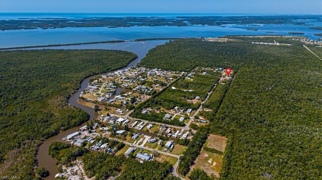 Double lot waterfront opportunity being offered together at 25 & 26 Plantation Dr in Plantation Island in Everglades City. Each lot measures 60 x 100, totaling .28 acres with an impressive 100 feet of water frontage. This property offers exceptional boating and fishing access with a direct route to the Gulf and only one high bridge between you and the open waters of the Ten Thousand Islands. You can be out to the Gulf in approximately 5 to 10 minutes, making this an ideal setup for boating enthusiasts and avid anglers. One side of the property features a beautifully maintained manufactured home with 1 bedroom and 1 bathroom, offered turnkey furnished and move-in ready. The home is connected to city water and has been well cared for, making it perfect for immediate use as a seasonal retreat or income-producing rental. The entire double lot is fully fenced, offering privacy and flexibility, ideal for pet owners or those looking for additional space. The second lot (26 Plantation) provides excellent potential to build a second structure or create a larger custom waterfront residence. A wooden dock is already in place, perfect for fishing or launching your boat, and the owners are including a canoe with the sale for added enjoyment of the surrounding waterways. This is a rare opportunity to own a versatile waterfront property with expansion potential in a peaceful Old Florida setting. Enjoy privacy, nature, and easy Gulf access while still being within reach of everything Southwest Florida has to offer.