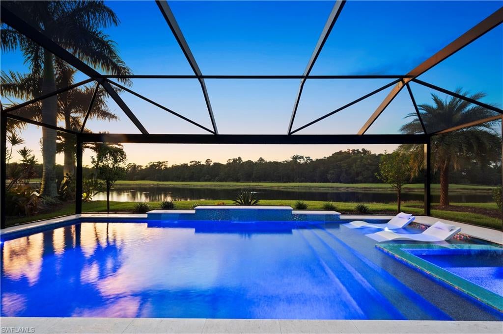 SPECTACULAR SUNSETS over the lake, golf course and protected nature preserve with unobstructed panoramic views—this is a setting worth coming home to! Enjoy it all from your custom pool and spa, surrounded by a travertine stone pool deck and a picture-window screen enclosure that keeps the view front and center. Located in the Prato/Pistoia neighborhood, one of the newer enclaves within Pelican Preserve, this 2018-built home combines exceptional outdoor living with IMPACT-RATED WINDOWS AND DOORS plus motorized lanai storm screens. The heated saltwater pool features a sun deck with an LED bubbler, while wireless spa controls make it easy to settle in and relax. Inside, the single-level Trevi floor plan offers 4 bedrooms, 3 full bathrooms, and 2,032 square feet. White kitchen cabinetry, under-cabinet lighting, a pantry with custom shelving, plantation shutters, and granite countertops add style and everyday convenience. Tile flooring and luxury vinyl in the bedrooms mean NO CARPET throughout, and custom closet systems in the primary bedroom help keep everything organized. Thoughtful improvements extend beyond the finishes: a whole-house Halo water filter and under-sink reverse osmosis system, added attic and garage-door insulation, and HVAC enhancements including a UV light and soft-start compressor. The immaculate 2-car garage features epoxy flooring, with generator hookup for added preparedness. A widened driveway, improved landscaping, and screened front entry with an additional retractable door screen round out the improvements. Furniture is negotiable. Pelican Preserve offers gated 55+ living with an extensive selection of amenities and activities including pools, fitness center, a restaurant, library, dog park, boardwalk, and nature trails. There are 12 pickleball courts, 8 tennis courts, a softball field, basketball court, lawn bowling, bocce ball, table tennis, billiards, and more! Golf is available through a separate optional membership. Included lawn care and landscaping services leave you more time to enjoy the community, whether you’re here for the winter or year-round. Ask your agent for the detailed feature list, then schedule your private showing to experience this exceptional view for yourself!