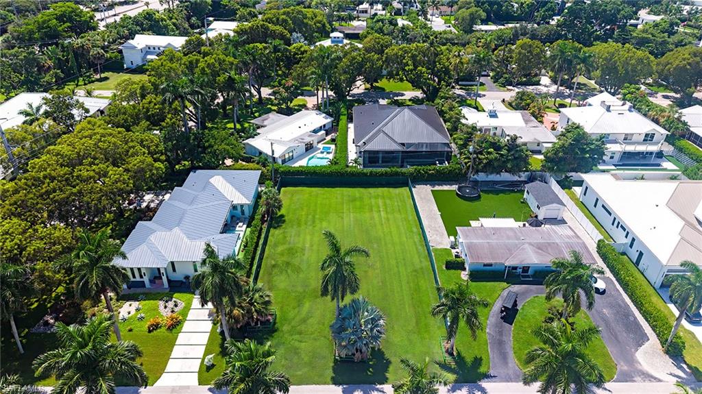One or more photo(s) has been virtually staged, AI generated or rendered.  A rare opportunity to create a truly exceptional residence in one of Naples’ most charming and increasingly sought-after downtown communities. This generously sized lot offers a combination of space, privacy, and a desirable building envelope, providing flexibility to envision a refined custom home with beautifully landscaped outdoor living spaces and a private backyard retreat. Set along quiet, tree-lined streets, the Lake Park neighborhood offers a sense of community and the timeless character of Old Florida. Mid-century cottages co-exist with thoughtfully renovated residences and newer construction, creating exciting potential for continued transformation and appreciation. Everyday living in Lake Park is effortlessly connected to the best of Naples. Top-rated local schools, nearby parks, acclaimed restaurants, and neighborhood amenities are all within easy reach. Just across US-41, the Gulf beaches are accessible by an easy bike or golf cart ride. With its generous dimensions, peaceful setting, and exceptional proximity to Naples’ most coveted destinations, this lot presents an opportunity for sophisticated coastal living in a neighborhood poised for an exciting future.