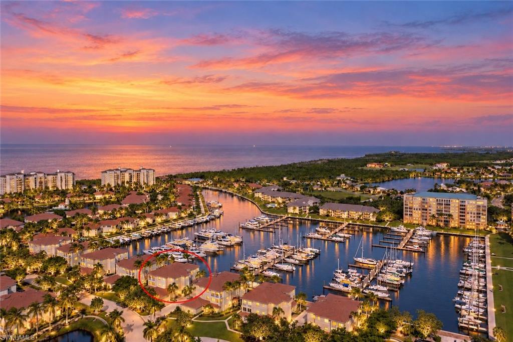 Experience the allure of marina-front living from this second-floor residence, accessed by a private elevator and offered turnkey furnished. This captivating location not only enjoys a heightened sense of arrival but also panoramic views of the north marina basin at Burnt Store Marina. This spacious and versatile layout, scores a “10” with a fabulous open plan bathed in natural light from the abundant windows and doors that surround this elevated condo. Two screened lanais keep you connected with the outside world and help you to embrace the relaxed coastal lifestyle while enjoying front-row seats to the activity of the marina. The expansive rear lanai stretches across the entire width of the home and features attractive tile flooring, screen enclosure, and captivating views of the marina basin. Whether sipping your morning coffee, enjoying afternoon breezes, or unwinding at the end of the day, this inviting outdoor retreat provides the perfect setting to watch boats cruise in and out of the harbor. Inside, the open and flexible floor plan offers an effortless blend of comfortable everyday living and entertaining space. The kitchen is flanked by two expansive breakfast bars that provide casual seating and gathering areas. The chef is sure to enjoy the magical cross breeze when they open the sliding doors on either side while whipping up their favorite meal to serve on the lanai Al Fresco style. With ample living space on either side for friends to gather this truly provides a great entertaining venue. The versatile secondary living area features handsome wood built-in shelving and a cozy fireplace, creating a warm and inviting setting that can serve as a comfortable family room or accommodate a separate dining area. Sliding glass doors open to a second screened lanai at the front of the residence, providing yet another peaceful spot to enjoy the Florida breeze. French doors have been added to connect the third bedroom, which is currently being used as a den. It boasts built-in wood shelving, making it equally suited as a home office, or for overflow accommodations. The spacious primary suite is a peaceful waterfront retreat, where sliding glass doors frame panoramic views of the marina and provide direct access to the rear lanai. A generous walk-in closet offers ample storage, while the inviting light-filled primary bath offers a contemporary vibe featuring a striking updated frameless walk-in shower with white textured wall tile and pebble flooring. An oversized vanity with dual sinks, and handsome garden tub surround compliments the vibe lending a fresh feel to the space. Thoughtfully positioned in a separate guest wing, the guest bedroom offers pleasing sunlight through the abundant windows while providing privacy and comfort for visiting family and friends. Convenient access to the updated guest bathroom featuring an handsome tiled shower with a sleek frameless glass enclosure and expansive vanity. 2 car garage is perfect for your vehicles.