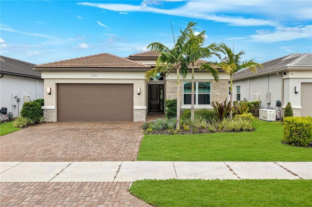 Thoughtfully upgraded with approximately $150,000 in builder upgrades and post-construction improvements, this beautifully appointed Pelican floor plan offers 3 bedrooms + den, 3 full baths & 1,954 SF of comfortable Florida living. Warm finishes, a highly functional floor plan & a spacious backyard ready to become your own tropical oasis make this home an inviting choice for those who want the benefits of a newer home. At the heart of the home, the inviting kitchen combines style with exceptional functionality. Wood cabinetry is paired with quartz countertops & backsplash, ambient cabinet lighting & stainless-steel appliances including a vented hood. A cabinet pantry, trash pull-out, pot & pan drawers & deep single-bowl sink provide the storage & functionality that make the kitchen equally suited to everyday living and entertaining. The kitchen opens seamlessly to the dining & great room areas, creating an easy flow throughout the main living space. Tile flooring extends through the main living areas, while LVP flooring in the bedrooms combine the warmth of wood with easy maintenance. Elegant crystal light fixtures add a touch of sparkle, while additional recessed lighting enhances the home's bright, welcoming atmosphere. Hunter Douglas shades that open from either the top or bottom provide flexibility for controlling light & privacy throughout the day. The primary suite is complemented by beautifully finished closets and a well-appointed bath featuring warm wood cabinetry, quartz countertops, frameless shower enclosure & tile extending to the ceiling. The additional baths carry the same elevated finishes, creating a cohesive look throughout. Two guest bedrooms provide room for family & friends, while the versatile den can serve as a home office, media room or additional sleeping space. Impact windows & doors provide year-round peace of mind, while the garage was extended an additional two feet and features an epoxy-finished floor & overhead storage rack. The laundry room includes a utility sink along with a new Samsung washer & dryer installed in 2025. Step outside to the screened lanai, where a knee wall & plumbing for a future outdoor kitchen provide a head start on creating your ideal outdoor entertaining space. Beyond the lanai, the spacious backyard offers a blank canvas to create your own tropical oasis—whether your vision includes expanded outdoor living, lush landscaping or plenty of open space to enjoy the Florida sunshine. Located in Valencia Trails, one of North Naples' premier 55+ communities, residents enjoy an exceptional array of amenities centered around a 43,000 SF clubhouse with a gourmet restaurant, poolside bar, resort-style pools, fitness center, pickleball, tennis, bocce, yoga, art studio, cooking classes, spa, dog park & an active social calendar. Move-in ready yet offering plenty of opportunity to make it your own, this beautifully upgraded Pearl is an exceptional place to begin your next chapter in Naples.