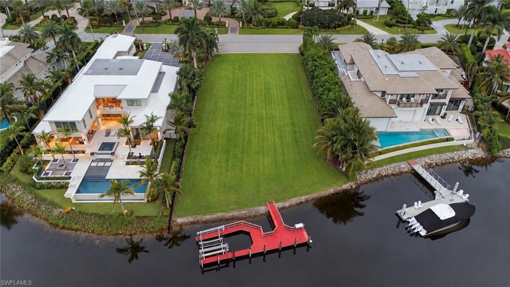 One or more photo(s) has been virtually staged, AI generated or rendered.  A rare opportunity in Port Royal, this exceptional waterfront property offers a combination of setting, privacy and potential that has become increasingly difficult to find. With more than 100 feet of frontage along the serene waters of Hidden Bay, the property enjoys expansive water views, remarkable privacy and very limited boat traffic. The generous building footprint provides an exceptional foundation for a future custom estate designed to maximize the long, open water views and tranquil character of Hidden Bay. The existing residence also offers flexibility for those who may wish to renovate and reimagine the property while taking full advantage of its substantial waterfront exposure. Adding to the lifestyle appeal is immediate eligibility for the all-new Port Royal Club, an anticipated premier private beach club offering elevated beachfront dining, recreation and relaxation. Just minutes from the celebrated restaurants, boutiques and galleries of Third Street South and Fifth Avenue South, as well as Naples’ renowned white-sand beaches, this property presents a compelling opportunity to secure an exceptional waterfront setting in one of Naples’ most coveted neighborhoods.
