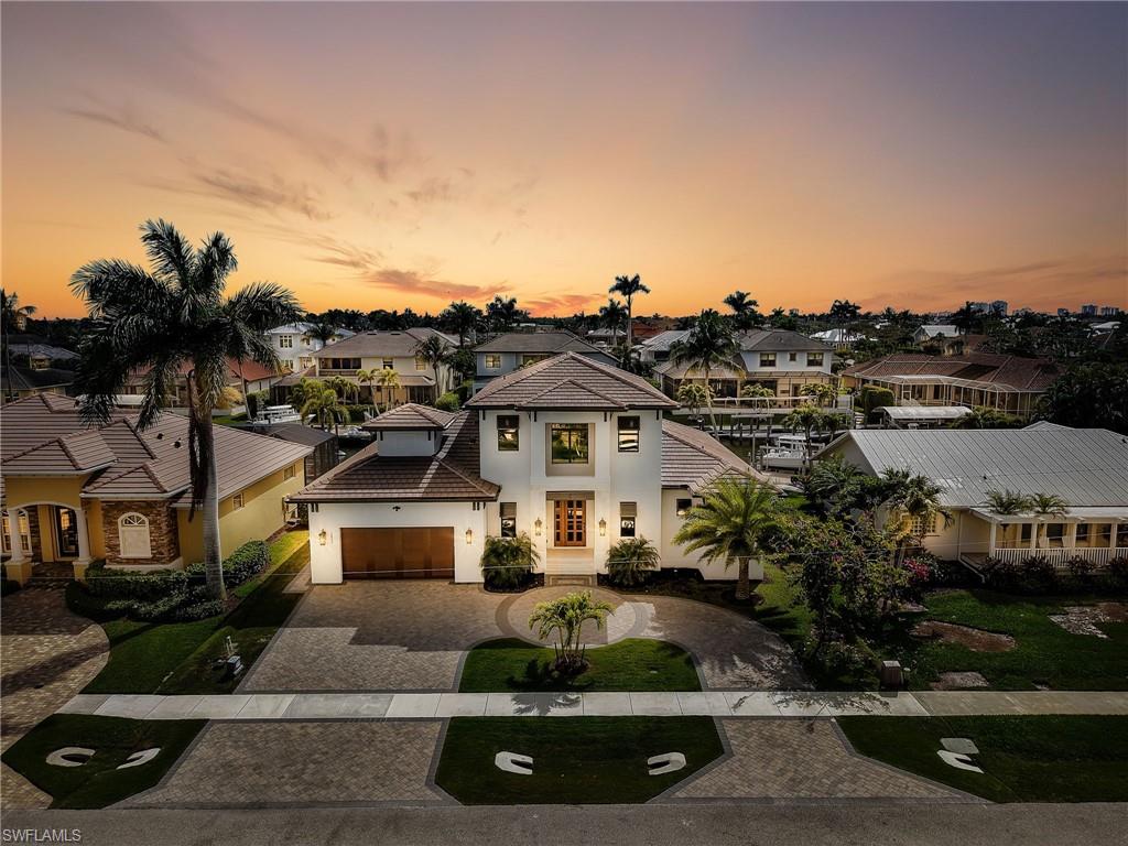 Discover the epitome of luxury living in this exceptional newer construction waterfront home on Marco Island. Offered TURNKEY—everything is included. This home features 4 bedrooms plus DEN and 3.5 bathroom! Boasting desirable southern exposure, a newer seawall, and direct Gulf access with quick passage to open water, this stunning residence offers the perfect blend of modern sophistication and coastal charm. Step inside to an expansive open-concept living space highlighted by soaring ceilings and an abundance of natural light. Walls of windows and sliding glass doors—featuring high-impact glass throughout—create a seamless connection between indoor and outdoor living while showcasing the home’s bright, airy design. Every element has been thoughtfully curated to deliver an atmosphere of refined elegance, from the welcoming grand foyer to the spacious living areas designed for both comfort and entertaining. At the heart of the home is a gourmet chef’s kitchen, complete with top-of-the-line appliances, custom cabinetry, and premium finishes that make both everyday living and hosting effortless. The outdoor space is a true private retreat. A generously sized pool deck surrounds a custom saltwater pool and spa, complemented by a fully equipped outdoor kitchen—perfect for relaxing afternoons, sunset gatherings, and year-round entertaining. This newer construction waterfront residence on Marco Island captures the essence of coastal luxury living, where contemporary design, exceptional amenities, and the beauty of the surrounding waterways come together to create a home that is truly extraordinary. Welcome to a serene lifestyle along the canals of Marco Island.