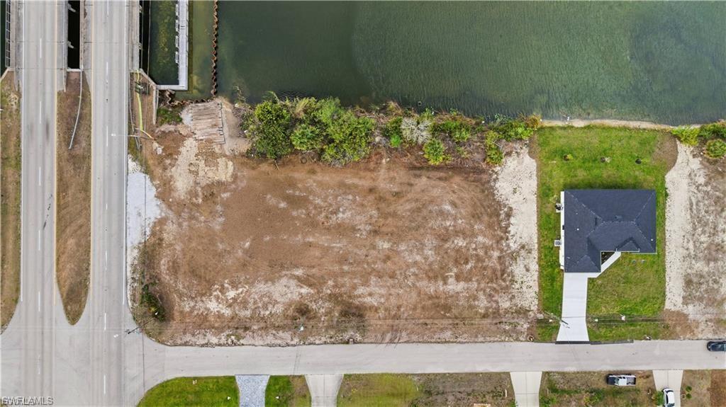 Clear lot on a freshwater canal in growing NW Cape Coral. Located just minutes from schools, shopping, dining, and golf, with excellent access to nearby major roads. The property is located in a fast-growing region in Cape Coral where new homes are popping up all around. You will also enjoy fishing from your own backyard and watching the SWFL wildlife play and hunt. Ideal for boating, kayaking, and enjoying the freshwater canal lifestyle. This property is perfect for homeowners or investors looking for a high-potential lot in one of Cape Coral’s fastest-growing areas. Don't miss this opportunity!