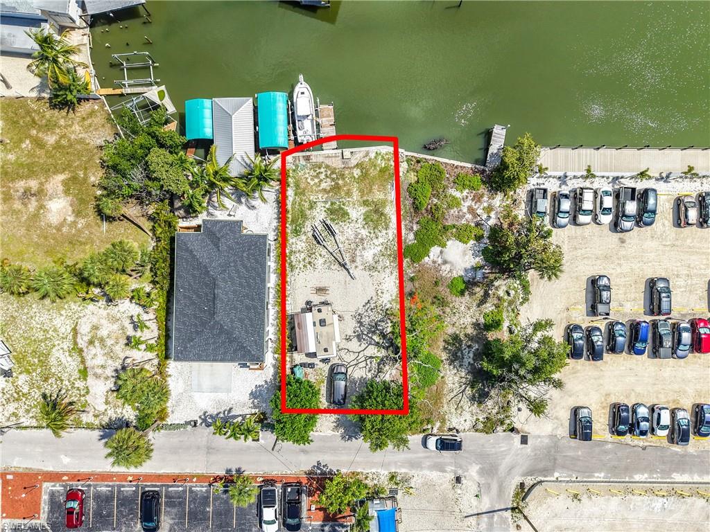 INVESTORS, DON’T MISS THIS RARE OPPORTUNITY! This prime 5,997+/- sq. ft. waterfront lot is ideally located within the highly desirable Santos Zoning District, offering endless potential and income-producing possibilities. Allowable uses include an office with a residential apartment above, duplex, bed and breakfast, single-family residence, water taxi operation, and more (please request the Zoning Verification Letter for complete details; agents can access the ZVL and survey in the MLS).
Whether you’re looking to build or invest, this property offers exceptional potential for strong returns—especially with its location in the highly sought-after WEEKLY RENTAL DISTRICT, creating incredible short-term rental income opportunities.
Perfectly situated directly across from the iconic Lani Kai Island Resort and just steps from the beach, Margaritaville Beach Resort, popular dining, and shopping.  This property combines unbeatable location with unmatched versatility. A truly unique investment opportunity in the heart of Fort Myers Beach!