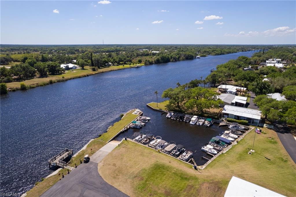AFFORDABLE RIVERFRONT COMMUNITY LIVING! Welcome to Oak Park Co-op, a peaceful 55+ retirement community nestled near historic Alva Village and surrounded by small farms, lush woods, and the Caloosahatchee River. Residents enjoy a range of amenities, including a fishing deck overlooking the river, a marina, various game courts, a helicopter pad for medical emergencies, and a community bus for outings and shopping trips. This remodeled manufactured home sits on a spacious corner lot and boasts several recent upgrades. Impact windows (2021) and a newer roof (2018) provide peace of mind, while new flooring throughout enhances the home’s modern appeal. The bedrooms feature brand-new carpet as well as the living areas. The kitchen showcases luxury vinyl plank flooring. The kitchen has been partially remodeled, including a new island for extra storage. Plus, the seller is offering a credit so you can select the countertop of your choice to personalize the space. Also GOLF CART INCLUDED WITH SALE! Don’t miss this opportunity to make Oak Park Co-op your home!