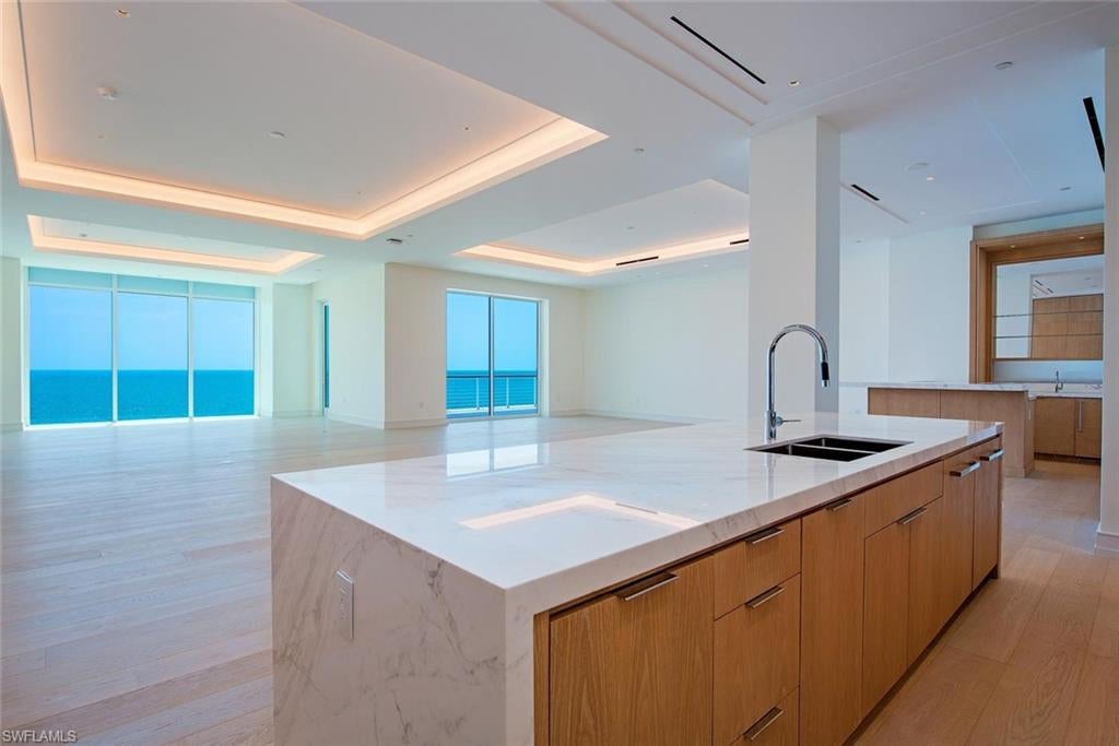 Experience unparalleled beachfront living at the newly completed Four Seasons Residences at the storied Naples Beach Club. Originally opened in 1946 by the Watkins family, this historic piece of the Paradise Coast has been reimagined as Florida's most anticipated luxury beachfront address. This exceptional four bedroom, four and a ½ bath residence is designed with the scale and comfort of a private estate, featuring 12-foot ceilings, light-filled interiors, a spacious west-facing corner terrace, and breathtaking Gulf views. A contemporary Beachwood palette showcases white oak cabinetry and doors throughout, complemented by Volakas marble kitchen countertops and backsplash, washed white oak flooring, Bianco Dolomiti marble in the primary and junior primary baths, and Vanilla Ice marble in the secondary baths. Impeccably designed by Champalimaud, the home features premium appliances, custom cabinetry, dual primary baths, expansive walk-in closets, seamless indoor-outdoor living, and two private entrances, including a direct elevator from the lobby. Four Seasons Residences at Naples Beach Club is an exclusive collection of just 58 beachfront homes offering 1,000 feet of pristine beach, championship 18-hole golf, a world-class spa, six dining venues, and the legendary Four Seasons 24-hour concierge and personalized services.