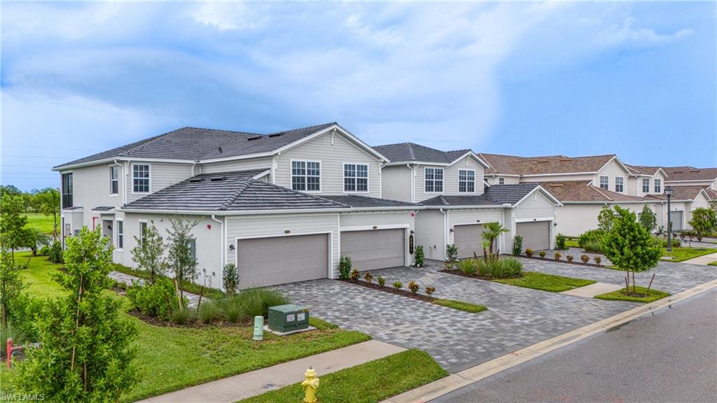 One or more photo(s) has been virtually staged, AI generated or rendered.  **GOLF MEMBERSHIP INCLUDED! 2025-BUILT FIRST-FLOOR CORNER COACH HOME WITH STUNNING WATER VIEWS!** Welcome to this GORGEOUS, nearly BRAND-NEW 2025-built, 3-bedroom, 2-bath ARROWHEAD floor plan coach home offering nearly 1,800 square feet of beautifully appointed living space in the highly desirable gated community of THE NATIONAL GOLF & COUNTRY CLUB AT AVE MARIA! Perfectly positioned on a peaceful CUL-DE-SAC, this exceptional FIRST-FLOOR CORNER residence offers beautiful CANAL AND LAKE VIEWS, abundant natural light, IMPACT-RESISTANT WINDOWS & DOORS, a spacious 2-CAR GARAGE, and a highly coveted GOLF MEMBERSHIP THAT TRANSFERS WITH THE PURCHASE! Step inside the inviting foyer, where the elegant dining area welcomes you to the right, while the spacious kitchen and living areas unfold to the left. The beautifully designed gourmet kitchen is a chef's delight, featuring gleaming QUARTZ countertops, stainless steel appliances, an oversized CENTER ISLAND, walk-in pantry, double sink, disposal, and picturesque water views! The bright and airy living and dining areas provide an inviting atmosphere for everyday living and entertaining, with expansive windows allowing natural light to pour in. Enjoy seamless indoor-outdoor living as sliding glass doors lead to your private ENCLOSED LANAI, where tranquil WATER VIEWS create the perfect backdrop for morning coffee, evening relaxation, or entertaining family and friends. Retreat to the spacious PRIMARY SUITE, featuring TWO WALK-IN CLOSETS, dual vanities, a private water closet, a beautifully appointed seamless walk-in shower, and DIRECT LANAI ACCESS! Two generously sized guest bedrooms offer abundant closet space, natural light, and convenient access to the second full bathroom with a tub/shower combination. Additional conveniences include IN-RESIDENCE LAUNDRY, a 2-CAR GARAGE, and WATER, INTERNET & CABLE INCLUDED IN THE ASSOCIATION FEES! Experience the ultimate Southwest Florida resort lifestyle at THE NATIONAL GOLF & COUNTRY CLUB, where your INCLUDED GOLF MEMBERSHIP provides access to the spectacular 18-HOLE CHAMPIONSHIP GOLF COURSE, driving range, putting green, short-game practice facilities, and pro shop! Residents also enjoy an impressive collection of resort-style amenities, including a magnificent CLUBHOUSE, on-site RESTAURANT, RESORT-STYLE POOL & SPA, FITNESS CENTER, TENNIS, PICKLEBALL, and BOCCE COURTS! Ideally located in the charming town of AVE MARIA in beautiful COLLIER COUNTY, this extraordinary residence combines modern comfort, breathtaking water views, and an exceptional golf and country club lifestyle. DON'T MISS YOUR OPPORTUNITY TO OWN THIS BEAUTIFUL GOLF-INCLUDED COACH HOME!