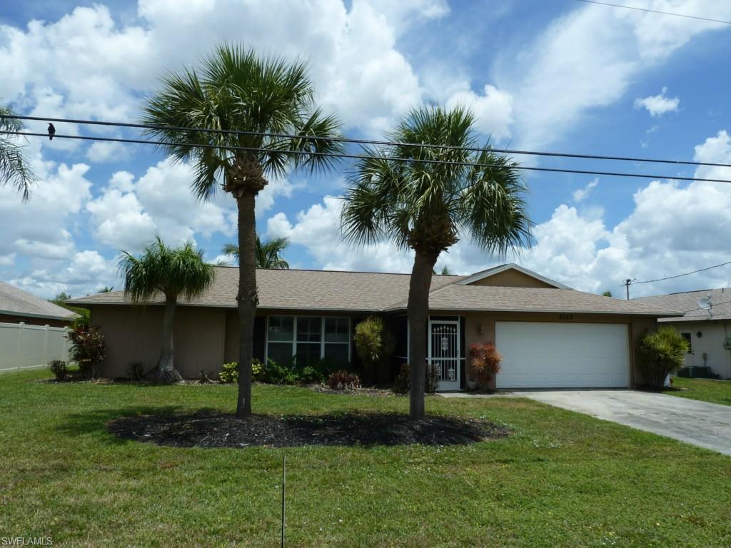 This is a fabulous floor plan with beautiful tile floors, large family room overlooks the lanai and pool. Move right in because the colors are professionally chosen . Nice fans and lighting. The pool has a beautiful diamond brite finish. Palm trees grace the back yard and the cantilever dock. The lanai and pool area are large and perfect for entertaining. It takes no time at all to get to open water with you boat and this home is ideally located for shopping and the bridge to Fort Myers. The roof was new in 2005, lots of upgrades, high end kitchen appliances and new cabinets