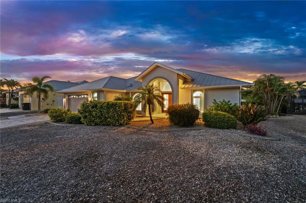 **ASSUMABLE FLOOD INSURANCE POLICY UNDER $1,000 PER YEAR!** Experience the ultimate Southwest Florida waterfront lifestyle in this beautifully remodeled 3-bedroom, 2-bath pool home, completely updated in 2019 and designed for effortless indoor-outdoor living. No hurricane or storm surge water has ever entered the home, offering an added level of peace of mind. Boaters will appreciate the exceptional direct, deep-water access providing an easy route to Pine Island Sound, the Gulf, nearby beaches, island destinations & some of Southwest Florida’s most renowned fishing grounds. The impressive waterfront setup features two boat lifts—10,000 lb & 7,000 lb—both equipped with GEM remotes, a boathouse with metal roof, composite dock with water & electric, plus a fish cleaning station. Inside, vaulted ceilings and abundant natural light enhance the open great room concept with a desirable split-bedroom floor plan. Expansive sliders extend the living space directly to the lanai, creating a seamless connection between indoors & out. The kitchen is the focal point of the home, showcasing a large island with waterfall-edge granite, granite countertops, tile backsplash, under-cabinet lighting, Bosch dishwasher, stainless steel appliances, abundant drawers & cabinetry, plus a pantry with convenient pull-out shelving. A separate beverage area in the dining room adds the perfect touch for entertaining. The spacious primary suite offers private lanai access through sliders, two walk-in closets and an en suite bath with dual sinks & a walk-in shower featuring multiple shower heads. Both guest bedrooms are generously sized and can accommodate king-size beds, while the guest bath conveniently doubles as a pool bath. Step outside to your private waterfront oasis featuring an electric & solar-heated pool with waterfall accent and a lanai spanning the full length of the home, including a generous under-truss area with plenty of room for dining, lounging & entertaining. Additional features include an in-residence laundry room with utility sink, 2-car garage with workbench, generator plug & transfer switch, new tile flooring throughout all main living areas with carpet in the bedrooms, accordion shutters throughout the entire home, and electric roll-down shutters protecting the lanai. Whether you're heading out for a day of fishing on Pine Island Sound, cruising to the Gulf, island hopping to nearby beaches or simply relaxing poolside, this home puts the best of the Southwest Florida boating lifestyle right outside your back door.