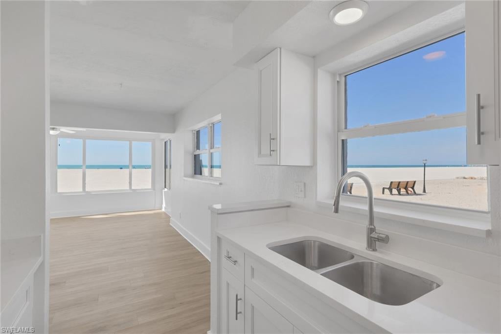 From early morning walks on the beach to the most picturesque sunsets imaginable, experience the very best of beachfront living in this rare, first-floor 2-bedroom, 2-bath residence in the highly sought-after Privateer on Fort Myers Beach. Perfectly situated within the community, this unit boasts truly direct, unobstructed Gulf-front views—an exceptional vantage point that many other residences simply do not offer. From your own home, take in sweeping panoramas of the widest stretch of the island’s sugar-white sands and the sparkling waters of the Gulf, where breathtaking sunsets and balmy coastal breezes become part of your everyday routine. Inside, the bright, open floor plan is filled with natural light from walls of windows framing the beach beyond. Thoughtful updates and improvements create a move-in-ready retreat, including new flooring, fresh paint, a new A/C system, stainless steel appliances, and beautifully refreshed kitchen and baths. The spacious Gulf-facing living area flows seamlessly, offering a relaxed indoor-outdoor connection ideal for morning coffee with the sunrise or evening cocktails as sun sets over the surf. Lovingly maintained and never rented, this condo blends nostalgic Old Florida charm with tasteful modern enhancements. The Privateer community itself is undergoing exciting revitalization, reflecting strong ownership and a proactive association. Residents enjoy direct private beach access, BBQ and picnic areas, scenic community patio area to watch sunsets, exciting landscape enhancements underway and a newly renovated community pool. Located on the tranquil south end of the island, you’re just minutes from the island’s vibrant comeback, with new and returning restaurants, shops, and entertainment adding to the energy and appeal. Importantly, this residence did not experience flooding from Hurricanes Helene or Milton, and all prior repairs have been completed—offering both peace of mind and lasting value. With nearly eight miles of pristine shoreline at your doorstep and unmatched, unobstructed beachfront views from one of the most desirable positions in the community, this is more than a condo—it’s a front-row seat to paradise and an extraordinary opportunity to own in one of Fort Myers Beach’s most iconic Gulf-front enclaves.