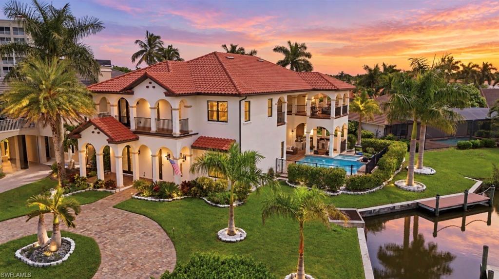 This home feels out of a storybook, European castle-inspired architecture, circular driveway, tropical landscape and incredible waterfront setting, this home is truly one of a kind. The front of the home faces the marina with beautiful open-water views beyond, while the river runs alongside the property giving this home a setting unlike anything else in the community. Wrapped with royal palms and Clusia for privacy, enhanced in the evenings with lighting. Multiple porches and verandas wrap the home, creating incredible places to take in the water views and watch the sunset light up the front of the house. Inside, the scale is just as impressive. 14ft ceilings on the first floor, 10ft upstairs. The home has been beautifully upgraded and freshly painted inside and out, so there is truly nothing left to do but enjoy. The chef’s kitchen has generous cabinet space both for storage and display. The oversized Island looks into the open dining/living room filled with sunlight and detailed with an impressive feature wall. The outdoor living is exactly what you want in Southwest Florida, with a resort-style pool and spa, swim-up bar and summer kitchen designed for entertaining. All exterior stone professionally deep-cleaned, sanded and sealed. Boaters, the location is hard to beat! Just steps from the marina, with storage and dock options available and direct access out to the Caloosahatchee River and Gulf. Three car garage with 14 foot ceilings complete with epoxy floors.  Big, beautifully finished, surrounded by water and completely move-in ready, this is one you need to experience in person! Residents of this gated community enjoy access to two heated swimming pools, two tennis courts, a private beach and riverside park, with an impressive 600-foot fishing pier overlooking the river. Boating enthusiasts will appreciate the exclusive 36-slip marina, Peppertree Pointe Marina at Water's Edge, accommodating vessels up to 35 +ft, along with convenient trailer storage and a private boat launch. From the marina, enjoy just 15 minutes to the sparkling Gulf waters and the world-renowned shores of Sanibel Island and Captiva Island.