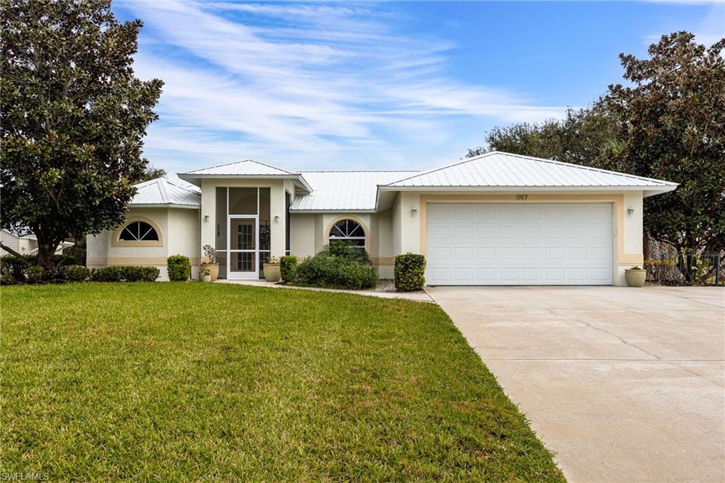 HOUSE + GUEST HOUSE + A STUDIO + A 5 CAR GARAGE, WITH 3 UNDER AIR on a .70+/- acre homesite with additional lot also available! COMES WITH A 1 YEAR HOME WARRANTY!  Located in one of the nicest sections of Port LaBelle, near the Port LaBelle Marina, and features professional landscaping, irrigation system (on well, for irrigation only) the houses are on central water. The main house features hardwood flooring, screened entry and a huge, screened lanai, 2 Bedrooms + a den / office that can easily be transformed back into a 3rd bedroom. The guest house is handicapped and wheelchair accessible. It features an open floor plan with hardwood flooring, large bathroom with handicapped features, a kitchenette, huge, screened lanai, and a THREE-CAR AIR-CONDITIONED GARAGE / WORKSHOP with a driveway on Rogue Avenue. On the walkway between the homes is a studio with air conditioning, bathroom and kitchenette. This property is ideal for multigenerational living! SELLER IS OFFERING SELLER CONCESSIONS FOR CLOSING COSTS!