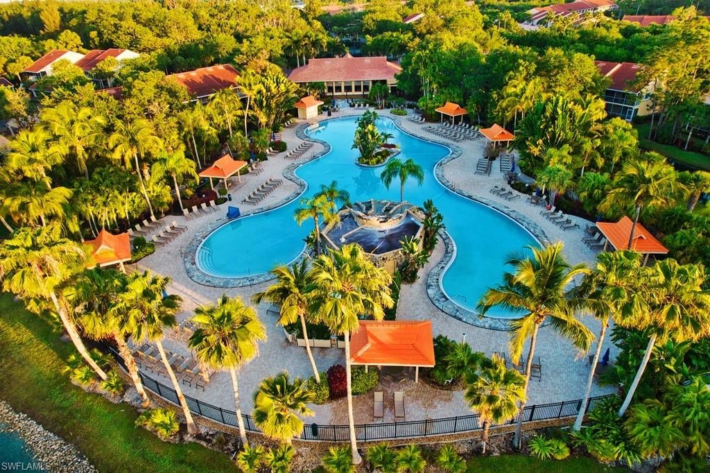 **Exceptional opportunity in Falling Waters!** If you’ve been waiting for the right combination of value, a garage, turnkey furnishings, and resort-style Naples living, this is one you won't want to miss! Surrounded by lush tropical landscaping and picturesque waterfalls, this inviting second-floor condo is priced to stand out and ready for its next owner. Step inside to a bright, open floor plan with soaring volume ceilings and an abundance of natural light. The spacious living area flows to the oversized screened lanai, providing the perfect place to relax, entertain, and enjoy Florida’s indoor-outdoor lifestyle. The cheerful eat-in kitchen offers abundant cabinetry, a cooktop, wall oven, and plantation shutters. The spacious primary suite features glass doors opening to the lanai, a large walk-in closet, and an ensuite bath with dual sinks, an upgraded shower, and additional storage. A comfortable guest bedroom, second full bath, and separate laundry room complete the well-designed floor plan.
Best of all, this condo is being sold turnkey furnished and includes a garage, making it easy to start enjoying your Naples getaway from day one. Falling Waters offers outstanding resort-style amenities, including one of the largest saltwater pools in Southwest Florida, a vibrant clubhouse with numerous social activities, tennis courts, bocce ball, shuffleboard, and a putting green—all surrounded by the community’s signature tropical landscaping and waterfalls. Ideally located just minutes from shopping, dining, medical facilities, downtown Fifth Avenue South, and the white sandy beaches of the Gulf, this property offers an outstanding opportunity for seasonal or full-time Florida living.