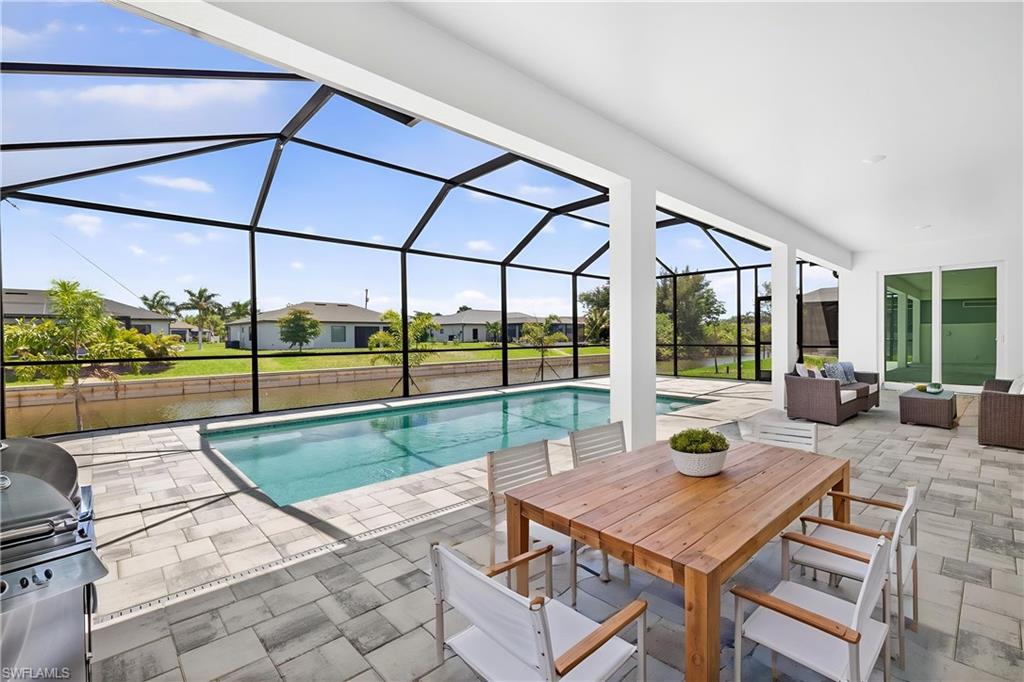 MOVE IN READY NEW CONSTRUCTION NO FLOOD ZONE WATERFRONT PARADISE WITH DUAL PRIMARY SUITES & HEATED POOL! Welcome to the Paradise Cove lll Plan, a stunning waterfront retreat designed for luxurious living and effortless entertaining! Nestled on a scenic freshwater canal, this expansive 4-bedroom, 3-bath home offers serene water views and the perfect blend of comfort and elegance. Step inside to a bright and airy great room, where soaring ceilings and a 16-foot triple slider invite natural light and seamless indoor-outdoor living. The gourmet kitchen is a chef’s dream, featuring soft-close, all-wood cabinetry, quartz countertops, stainless steel appliances, and an oversized walk-in pantry—perfect for hosting and everyday convenience. This home boasts two luxurious primary suites! The main suite is a private retreat, large enough for a king-sized bed and a cozy seating area. Enjoy direct lanai and pool access, plus a spa-inspired ensuite with a freestanding soaking tub and walk-in shower. The second primary suite includes its own full bath—ideal for guests or multi-generational living—and also serves as a convenient pool bath. Outside, take in the breathtaking canal views from your expansive under truss lanai, or enjoy year-round swimming in the heated pool. Whether you love kayaking, fishing, or simply unwinding by the water, this home delivers the ultimate Florida lifestyle! Built by a trusted local builder, this home offers exceptional value with impact windows for added security and lower insurance costs, no flood zone for peace of mind and savings, and a 10-year structural warranty for lasting confidence. One or more of the photos have been virtually staged. This is The Paradise Cove lll Plan