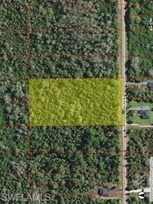 Situated near Everglades Blvd and 40th Ave SE, this 5-acre property offers potential in Golden Gate Estates. According to information provided by the previous seller, a 2006 DEP assessment identified the majority of the land as uplands. The historical findings suggest the possibility of subdividing the property into two parcels and constructing homes without wetland impacts, potentially avoiding the need for an Environmental Resource Permit (ERP). Subdivision feasibility, buildability, and permitting requirements must be independently verified under current regulations. Buyers are encouraged to obtain an updated environmental assessment and complete their own due diligence. Conveniently located near the I-75 overpass on Everglades Blvd, the property is minutes from Everglades Food Mart and Big Corkscrew Island Regional Park, and approximately 25 minutes from Collier Blvd or Ave Maria.