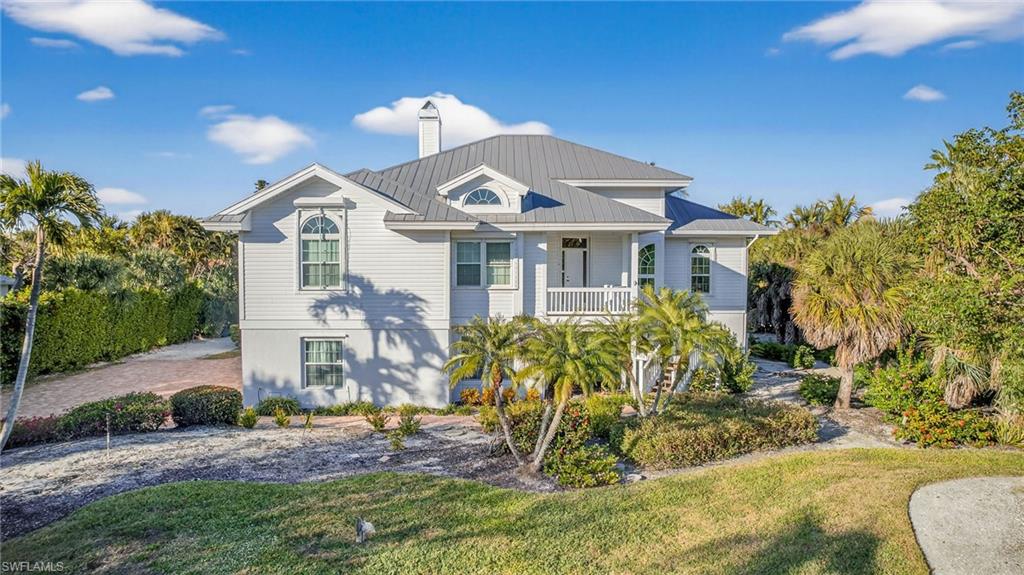 On the tranquil western end of Sanibel, this waterfront retreat offers direct access to the Gulf and a life shaped by sun and sea. Soaring 14-foot ceilings and a wide-open living space create an atmosphere of effortless elegance, while a wall of pocketing glass doors dissolves the boundary between indoors and out. Go onto the expansive deck, where a spa invites calm reflection, the staircase leading to a shimmering pool and generous patio, and beyond, to a private 15-foot canal-side dock. From here, drift past serene tidal bays and protected lands through Blind Pass to the Gulf and Pine Island Sound. The primary suite is a sanctuary of light and space, wrapped in floor-to-ceiling glass with tranquil views of the canal and deck. Its spa-like bath, complete with dual vanities, a walk-in closet, soaking tub and separate shower, offers indulgent comfort. A private guest suite with en-suite bath ensures a warm welcome for family and friends. On the eastern side of the property rests a rare and storied treasure: a historic Calusa Indian mound, honoring the legacy of the ancient mariners who once sought these elevated shores close to rich coastal estuaries.