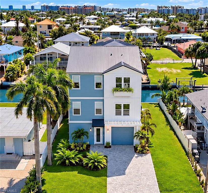One or more photo(s) has been virtually staged, AI generated or rendered.  NEW CONSTRUCTION | CANAL-FRONT POOL HOME | ELEVATED COASTAL LUXURY! Experience the best of the Fort Myers Beach lifestyle in this exceptional new-construction coastal residence built by Millworth Perkins. This elevated 4-bedroom, 3-bath home blends modern luxury, thoughtful design, and the relaxed elegance of island living. Featuring all-new construction and attention to detail throughout, this residence is designed to deliver the perfect combination of comfort, style, and functionality.

The thoughtfully designed floor plan offers a seamless flow for everyday living and entertaining, while a private elevator, currently being installed, will provide added convenience between levels. A private swimming pool is also being installed, creating your own backyard oasis—the perfect setting for relaxing, entertaining, and enjoying the Florida sunshine.

Situated on a waterfront homesite with a brand-new seawall, this property offers an incredible opportunity to embrace the boating lifestyle right from your backyard. Enjoy canal-front living with access to boating, fishing, and time spent on the water. When it's time for the beach, take a short stroll to the beautiful sugar-white sands of Fort Myers Beach and enjoy the refreshing Gulf breezes.

Conveniently located near local dining, shopping, and island attractions, this home combines waterfront living with beachside convenience. Built to current building codes and modern construction standards, this exceptional residence offers the benefits of contemporary construction in a highly desirable coastal setting.

Whether you're searching for a full-time residence, seasonal getaway, or investment opportunity, this outstanding property offers the opportunity to experience the best of Fort Myers Beach living. Your coastal lifestyle awaits!