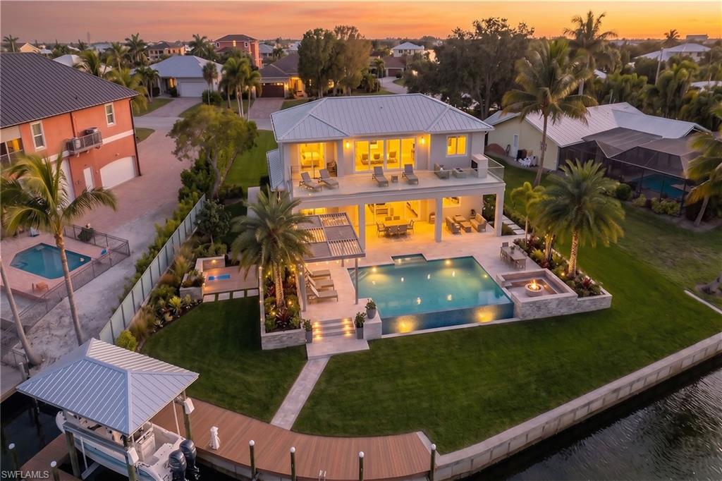 One or more photo(s) has been virtually staged, AI generated or rendered.  With a seawall completed in 2016, this homesite is ready for your dream home. Located in the desirable, mid-island, Glenview neighborhood, this homesite is set in one of the desired enclaves on Fort Myers Beach. This extraordinary lagoon-front homesite offers a rare opportunity to create a custom waterfront estate on a scale seldom found on the island. Positioned on an over-sized .42-acre parcel spanning more than 18,000 square feet, the property enjoys a striking setting on intersecting waterways, creating an exceptional sense of openness, water presence and long, dynamic views. Randy Lane is recognized for being among the highest elevations on Fort Myers Beach, a desirable characteristic that enhances peace of mind and long-term value. Combined with deep water access, the location is ideal for boating enthusiasts seeking effortless access to the bay and Gulf beyond, while enjoying the calm and beauty of a protected lagoon setting. The generous dimensions of this homesite provide a rare canvas for architectural creativity, allowing for a thoughtfully designed residence that embraces indoor-outdoor living, expansive outdoor entertaining areas and resort-style amenities. A second-story design would unlock beautiful bay views, adding another layer of visual interest and lifestyle appeal while capturing coastal breezes and stunning sunsets. This premier location blends privacy, prestige and proximity to the best of Fort Myers Beach.Whether envisioned as a primary residence or a refined coastal retreat, this exceptional homesite offers the foundation for a one-of-a-kind waterfront lifestyle in one of Southwest Florida’s sought-after settings. Virtual concept photos of a completed home are included in this listing.