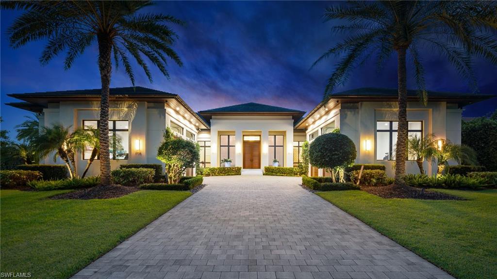 Created for those who value exceptional design, effortless entertaining and immediate access to the water, this custom 2019 residence captures the essence of sophisticated Naples living. Set on an oversized .59-acre homesite with long western views across Hurricane Harbor, the single-story home offers nearly 5,400 square feet under air in a remarkably private setting just minutes from the beaches, downtown Naples and the city’s celebrated dining, shopping and cultural scene.

Designed by Falcon Design and built by BBA Development, the residence flows beautifully from refined interiors to expansive outdoor living. A dramatic wall of pocketing glass disappears to unite the great room with the covered lanai, where afternoons by the pool transition to cocktails at sunset, dinner alfresco and evenings beside the outdoor fireplace. Beyond the pool, an intimate fire pit overlooks the dock and sunset water views ~ the perfect setting to end your day.

At the heart of the home, a spectacular chef’s kitchen is equally suited for intimate evenings and grand-scale entertaining. A 60-inch Wolf six-burner range with griddle, charbroiler and double ovens is complemented by separate Sub-Zero refrigerator and freezer columns, and adjoining wet bar with wine refrigeration and ice maker. Striking bookmatched quartzite backsplash and extensive custom cabinetry elevate the space, while the adjoining service kitchen adds a Miele built-in coffee system and steam oven, Gaggenau refrigeration and additional dishwasher—creating an exceptional culinary and entertaining environment.

Legno Bastone wood floors, custom millwork, architectural ceiling details, a family media room and private office bring warmth and understated sophistication throughout. Four ensuite bedrooms are complemented by a private poolside cabana/VIP suite, offering exceptional accommodations for family and guests. The serene primary suite features a beautifully curated dressing room and spa-inspired bath.

For the boating enthusiast, approximately 77 feet of waterfront, a private dock, 24,000-lb boat lift and two PWC lifts place the Naples waterways—and Gulf beyond—just outside your door. The exceptional four-car garage features soaring ceilings designed to accommodate automotive lifts in all four bays, creating the potential to house up to eight vehicles—an extraordinary amenity for the automobile collector. A whole-house generator, ELAN automation, Lutron lighting, impact glass and motorized screens and shutters further complement a residence created for effortless living.

Welcome home to a place where mornings can begin on the water, afternoons unfold at the beach and evenings take you to the dining and energy of downtown Naples before returning to the privacy of your waterfront retreat. Here, sophisticated single-level living, exceptional entertaining and the freedom of Gulf access come together—all remarkably close to the very best of Naples.