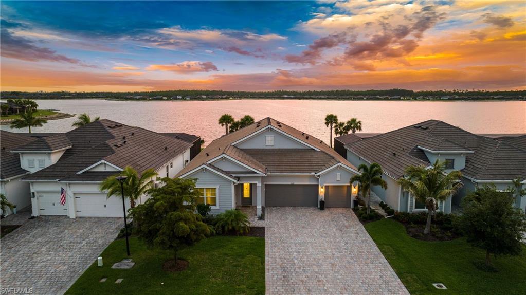 PRICED TO SELL! Sunset Views over a Mile-wide Lake, with a Private Dock and Sea-Doo! Welcome to 13682 Blue Bay Cir, nestled in the picturesque, lakefront community of WildBlue, where resort-style living meets serene luxury. This remarkable FULLY FURNISHED home boasts four spacious bedrooms, a den, three full bathrooms, and an expansive 2,704 square feet of living space adorned with upgraded porcelain plank tile floors throughout.

Step through the front door and into a sunlit, open-concept layout that effortlessly blends elegance with functionality. The inviting living spaces are ideal for everything from cozy family nights to lively gatherings, with large windows flooding every space with natural light.

At the heart of the home lies the bright and spacious island kitchen, a dream for chefs and entertainers alike. It features soft-close shaker-style cabinetry, gleaming quartz countertops, matching quartz backsplash, stainless steel appliances, a natural gas cooktop, a convenient coffee bar, and a walk-in pantry. The seamless flow into the dining area and great room ensures effortless entertaining and everyday living.

Step outside to an outdoor living area designed for ultimate relaxation and enjoyment. The upgraded travertine pool deck surrounds a sparkling heated pool and spa, while the large covered lanai and fully-equipped natural gas outdoor kitchen offer the perfect setup for al fresco dining or weekend barbecues. All of this is complemented by breathtaking sunset views over the nearly 300-acre recreational Lake Vista, including a private custom dock with a boat slip and an option to purchase a 2024 Sea Doo GTI 170 with only 5 hours!

For peace of mind during storms, the home rests in one of the lowest risk flood zones in Lee County. All windows and doors are hurricane impact rated, the covered lanai includes an automatic hurricane roll-down screen, and all WildBlue residents have the ability to add a natural gas whole-home generator.

WildBlue's amenity peninsula provides panoramic views of the nearly 600-acre WildBlue Lake, featuring a resort-style pool, separate lap pool, sandy lakeside beach, fitness center with studios, locker rooms with saunas, spa, a full-service restaurant and bar, poolside bar and grill, tennis and pickleball courts, a pro shop, basketball, boat ramps to over 800 acres of freshwater lakes, boat slip rentals, and more.

Don't miss the chance to turn this dream into your reality; schedule your private showing today.
