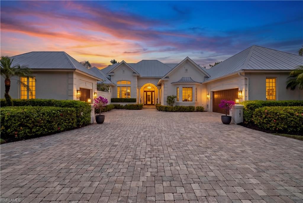 One or more photo(s) has been virtually staged, AI generated or rendered.  Enjoy the best of Naples living in this beautifully appointed Coquina Sands residence, where spacious interiors, inviting outdoor spaces, and a desirable coastal location create the perfect setting for everyday living and memorable gatherings with family and friends. Just moments from the Gulf beaches, Naples Beach Club, a Four Seasons Resort, and the shopping and dining of downtown Naples, the home places you close to everything that makes Naples special.

Situated on a lushly landscaped .41-acre lot, the residence offers over 4,000 square feet of living space with four bedrooms, five bathrooms, a den, a private office, and a three-car garage. Soaring ceilings, detailed millwork, French doors, and abundant natural light enhance the spacious living and dining areas, offering plenty of room to gather, entertain, or enjoy a quiet evening by the fireplace. The well-appointed kitchen features a six-burner gas range, convection ovens, dual dishwashers, generous counter space, and a breakfast bar, making it equally suited for casual mornings and entertaining guests.

The primary suite offers a peaceful retreat with direct lanai access, two walk-in closets, and a spacious bath featuring dual vanities, a soaking tub overlooking a private tropical courtyard, a walk-in shower, and a separate vanity area. En suite guest bedrooms provide comfort and privacy for visiting family and friends, while custom closets and generous storage space throughout the home provide plenty of room to keep everything neatly organized.

Step outside to an expansive west-facing covered lanai, where afternoons by the pool and spa, outdoor dinners, and evenings spent with friends become part of everyday life. Multiple seating and dining areas create an inviting setting for entertaining, surrounded by lush tropical landscaping that offers a beautiful sense of privacy.

Additional features include impact-resistant windows, newer air conditioning systems, a Generac generator, and a climate-controlled garage with an electric vehicle charger. The expansive pavered circular driveway enhances the home's curb appeal while providing generous parking space for family and guests.

Whether enjoying a relaxing day at home, heading to the beach, or spending an evening in downtown Naples, this Coquina Sands residence offers the space, comfort, and location to enjoy it all.