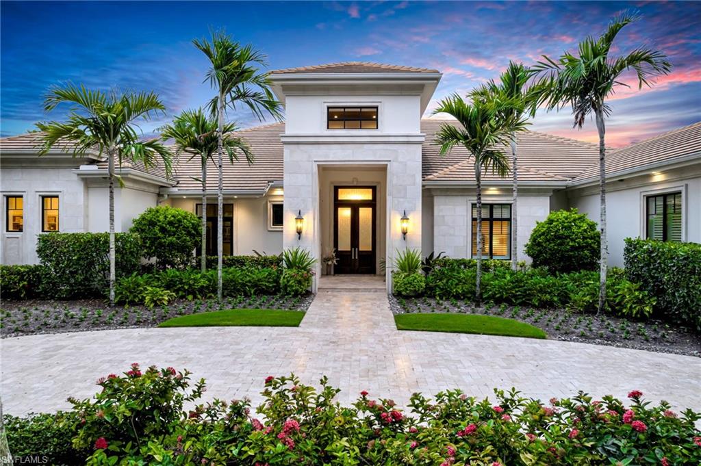 An extraordinary combination of space, privacy, and collector-worthy garage capacity distinguishes this lakefront estate at 385 Colony Drive in Bay Colony Shores. Occupying one and a half lots at the end of a cul-de-sac, the residence encompasses nearly eight thousand square feet under air, with an expansive layout that brings exceptional versatility to luxury Naples living. For the automobile enthusiast, garage accommodations for up to twelve cars introduce a defining feature: the ability to house an extensive collection within your own private estate. Paired with the generous homesite and substantial living space, this offering deserves the attention of buyers seeking something distinctive. The main residence features four spacious bedrooms, two offices, and two gyms, providing dedicated settings for work, wellness, and relaxation. An attached guesthouse with two bedrooms and two baths extends the accommodations, allowing visitors to enjoy their own retreat while remaining connected to the home. At the heart of the residence, a kitchen with dual islands offers generous space for preparation and gathering, equally suited to intimate evenings and larger celebrations. A walk-in wine room adds another dimension to entertaining, keeping favorite vintages close at hand. Outdoors, the expansive covered lanai frames beautiful lake views and a striking waterfall-edge pool. Western exposure brings the evening sky into focus, creating an inviting backdrop for sunset gatherings, leisurely afternoons by the water, and dinner overlooking the lake. The setting encourages you to linger, with space to entertain beneath the covered lanai or simply enjoy the changing light across the water. From its generous grounds to its remarkable garage and separate guest accommodations, this estate offers the flexibility to make Naples living distinctly your own. Discover the possibilities of this exceptional Bay Colony Shores address, and arrange a private showing to experience the scale, setting, and lifestyle that distinguish this property.