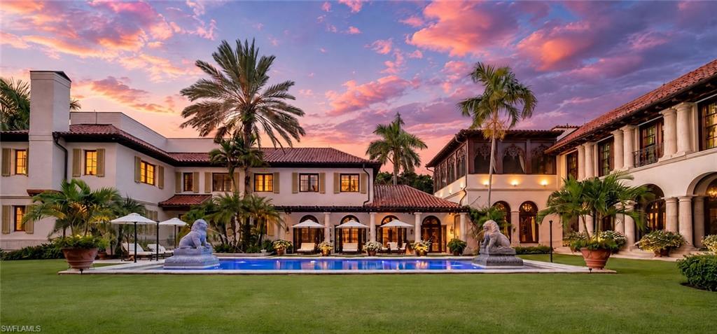 One or more photo(s) has been virtually staged, AI generated or rendered.  Set behind its own private gates, 3200 Green Dolphin Lane encompasses nearly one acre with coveted southwestern exposure, a scale rarely found in Port Royal, one of the most exclusive neighborhoods in the country. As the afternoon light moves across the lush tropical grounds, the setting feels entirely removed from the world beyond it. An intricate mosaic pool and expansive outdoor living spaces create a tranquil private resort for days by the pool, sunset cocktails and evenings beneath the palms.
Inside, nearly 14,000 square feet unfolds with the scale to entertain and the warmth to live comfortably every day. Craftsmanship from around the world is woven throughout the home. Honduran mahogany doors, gold-leaf ceilings, hand-painted Italian frescoes, custom Murano glass chandeliers, hand-carved woodwork, rosewood flooring, natural stone and Venetian plaster are complemented by more than 50 handcrafted marble columns throughout the interiors and travertine columns outdoors, creating a residence that feels entirely one of one.
The primary suite is a peaceful retreat, distinguished by intricate murals created in Venice, a spa and shower crafted entirely in marble and a private outdoor area designed to feel like a luxury resort.
Beyond the formal living and dining rooms, the home opens to an expansive family room, a private movie theater, library and speakeasy with substantial wine storage. An attached guest residence with a separate kitchen offers family and guests complete privacy while remaining seamlessly connected to the main home.
Behind the beauty is a standard of construction intended to endure for generations, including more than 300 pilings, poured concrete walls and floors, a prefabricated concrete roof system and 12 inches of insulation. A 200 kW whole-house generator provides additional security and self-sufficiency.
Just steps from the beach and the highly anticipated new Port Royal Club, the property offers coveted eligibility for membership. The spectacular new beachfront clubhouse will feature multiple dining venues, indoor and outdoor bars, a beachfront pool and cabanas, and private beach access.
In Port Royal, where properties of this scale have become exceedingly scarce, nearly one acre represents far more than land. It creates privacy, presence and the freedom to live expansively. Combined with globally sourced craftsmanship and uncompromising construction, 3200 Green Dolphin Lane is a legacy property that would be nearly impossible to replicate today.