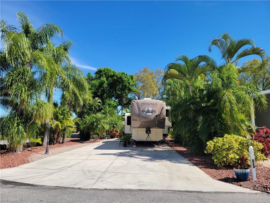 This neatly landscaped corner RV lot , which backs up to a green common area, provides a comfortable atmosphere and offers plenty of space for entertaining with much privacy. The property boasts a paver patio in the rear and a nice sitting area to the side.  The air conditioned accessory building is partially finished with a washer, dryer, small refrigerator, shelves and provides plenty of storage. This outbuilding has had updated electrical that was permitted. Imagine yourself relaxing on this unique property!  Cypress Woods RV Resort is a Luxury ownership Resort.  Amenities include two pools and hot tubs, shuffleboard, tennis and pickleball courts.  The Town Center has a community room, card room and Great Room with stage.  there is also a large catering kitchen for the numerous events held throughout the year.  The Welcome center has a additional card/community room and library. Also a day spa and 24 hour gym!  The resort is a friendly gated community providing plenty of additional activities, such as cornhole, water aerobics, and much more.  Conveniently located close the everything South West Florida has to offer.