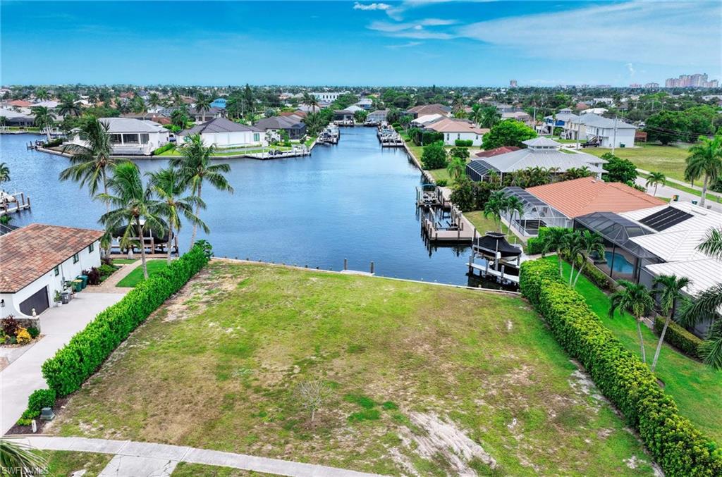 **An Exceptional Wide-Water Homesite in Marco Island's Center Island North Neighborhood.** Positioned on an oversized corner lot with desirable southern exposure, 1511 Jamaica Court offers approximately **.27 acres and 116 feet of waterfront** overlooking an expansive bay and long converging waterways. The wide-open setting creates exceptional water views and an impressive backdrop for a new custom residence, pool and outdoor living areas. This flat, grassy homesite is ready to build, with an existing seawall and **water-indirect Gulf access with one bridge**. Generous lot dimensions of approximately **105' x 116' x 121' x 117'** provide substantial space to design a residence that takes full advantage of the southern exposure, waterfrontage and views. Cable, electric, phone and trash service are available. A rare opportunity to build new on a sizeable Marco Island waterfront lot where **southern exposure, big water and long views come together.**