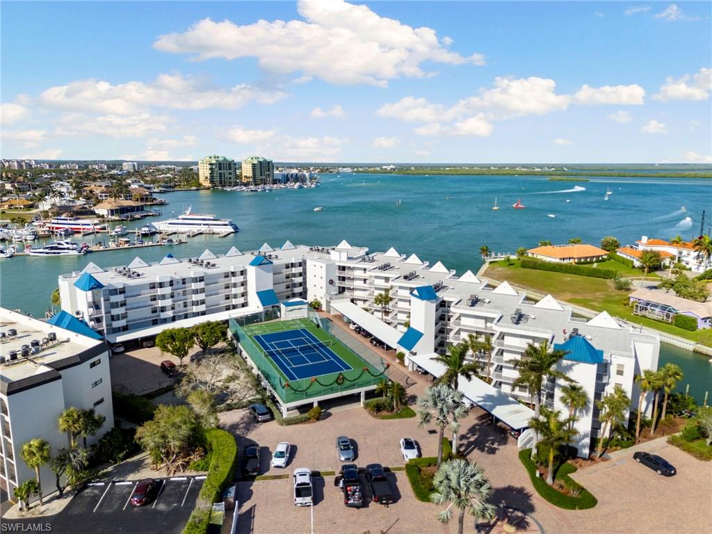 Step into coastal luxury with this rare 2-bedroom, 2-bathroom waterfront residence complete with a dedicated office, offering 1,640 sq. ft. of living space in historic Old Marco. Boasting a grandiose, unobstructed East-facing view over Factory Bay, this condo is one of a strictly limited number of units in the building offering this coveted vantage point. Enjoy breathtaking sunrise reflections over the water every morning directly from your kitchen and family room overlooking Factory Bay.

Designed for the ultimate boating and fishing lifestyle, enjoy direct water access right from your backyard—cast off into the Gulf of Mexico, cruise north to Naples, or head south to explore and fish the world-renowned Ten Thousand Islands. The property includes the rare convenience of two deeded parking spaces. Complex amenities feature a sparkling waterfront pool, spa, clubhouse, tennis courts, fishing pier, meticulously maintained tropical grounds, and inviting communal spaces. Situated in the heart of charming Old Marco, you are just a short distance to iconic waterfront dining, local marinas, historic landmarks, and boutique shopping.